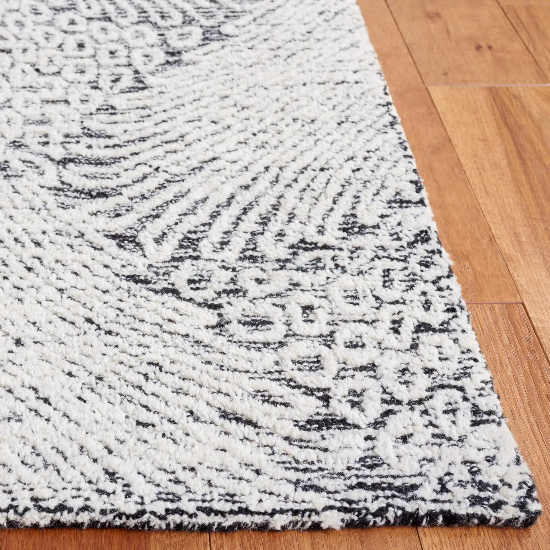 Ebony Wavy Chevron Hand-Tufted Wool Rug in Black / Ivory in a styled room