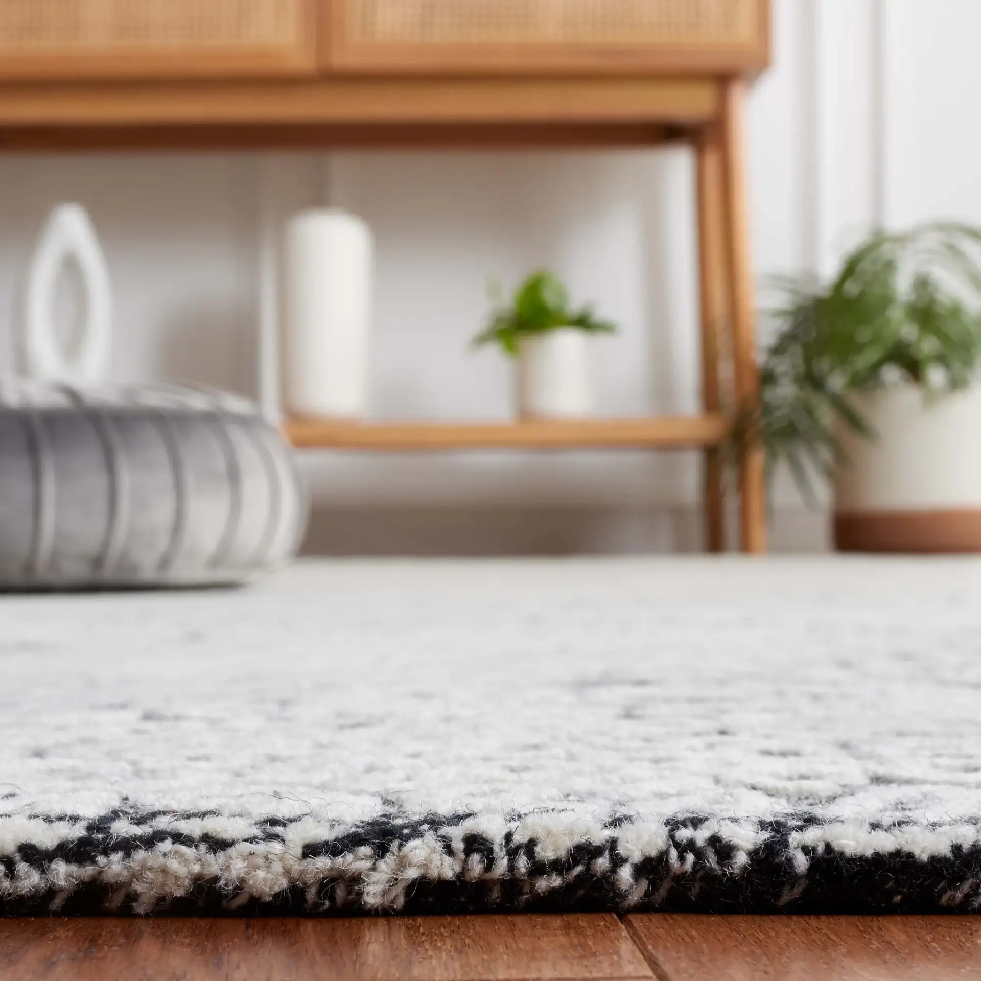 Ebony Wavy Chevron Hand-Tufted Wool Rug in Black / Ivory in a styled room