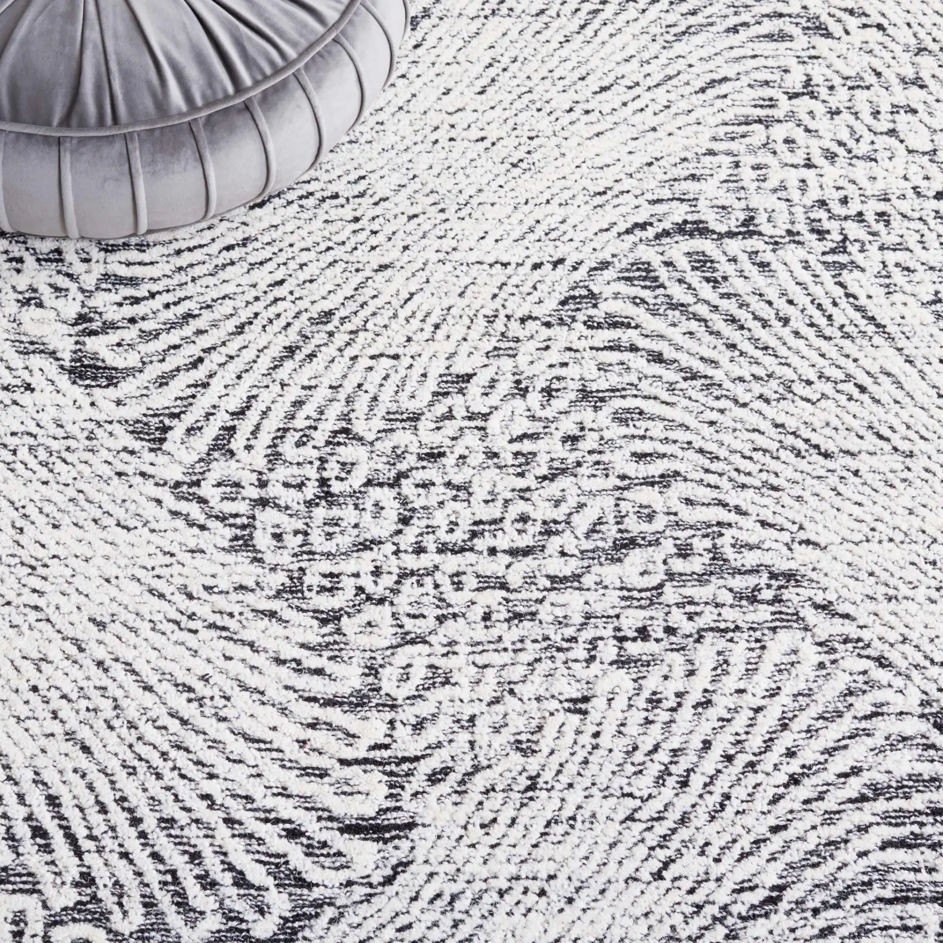 Ebony Wavy Chevron Hand-Tufted Wool Rug in Black / Ivory in a styled room