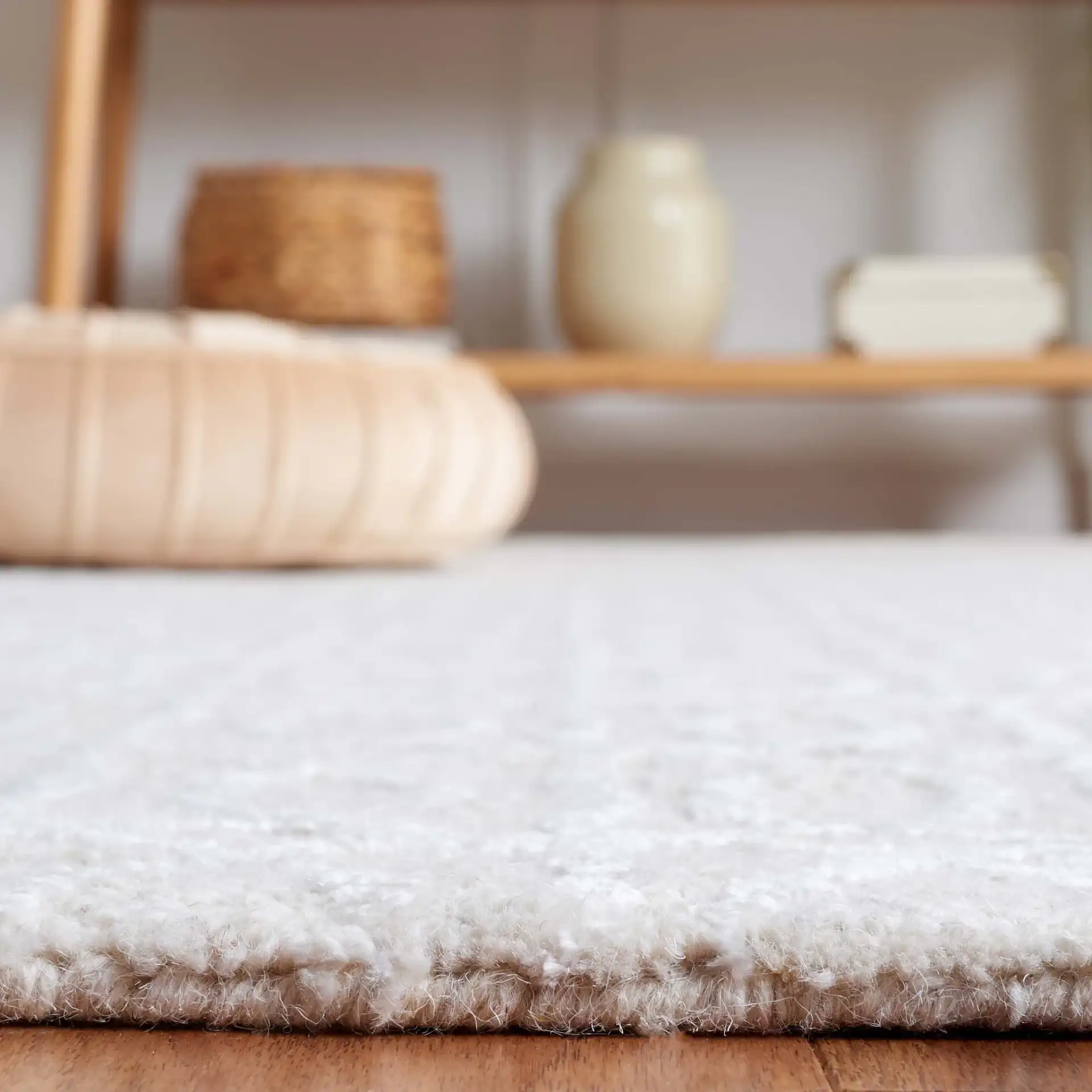 Ebony Interlocking Rings Hand-Tufted Rug in Beige / Ivory in a styled room