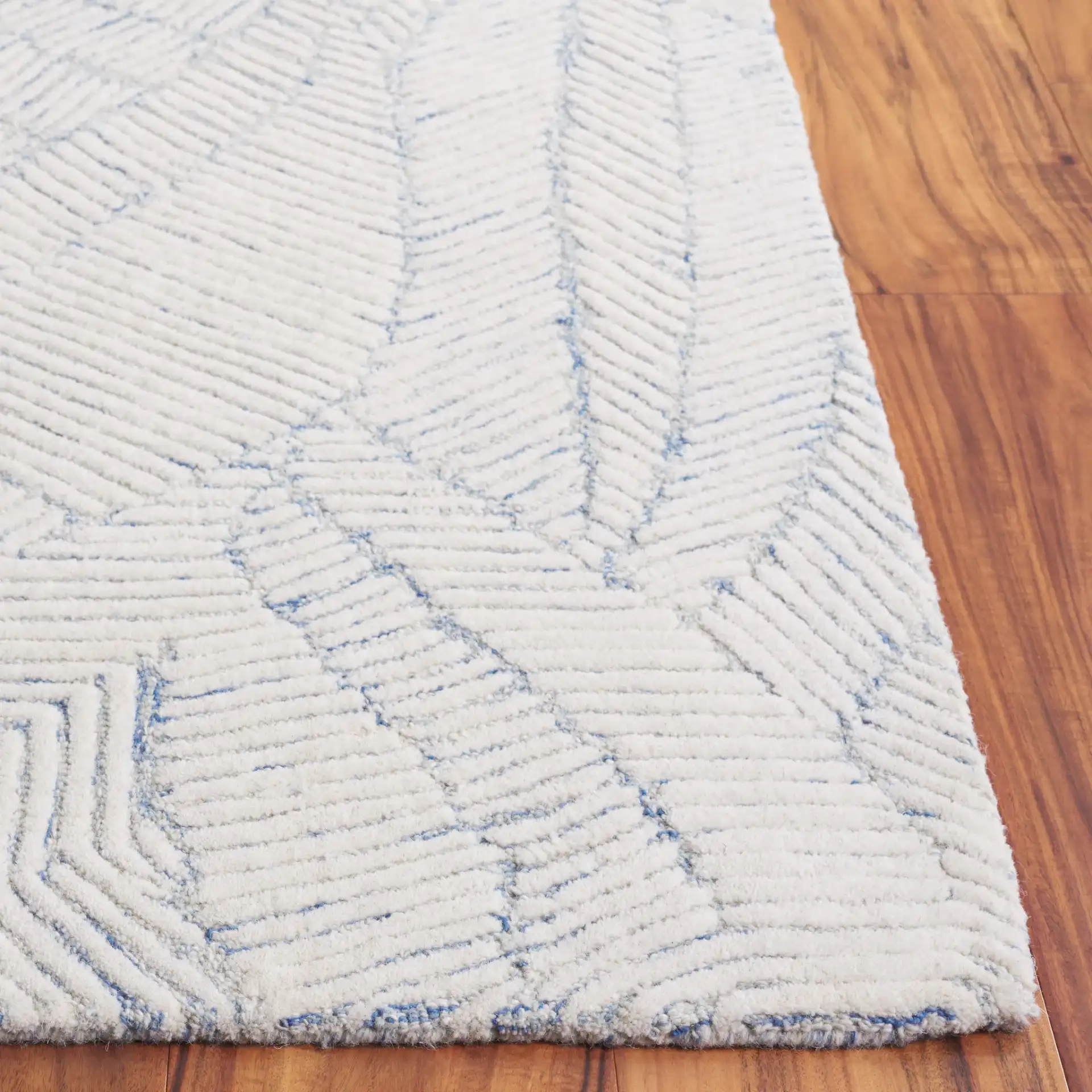 Ebony Leaf Hand-Tufted Wool Rug in Blue / Ivory in a styled room