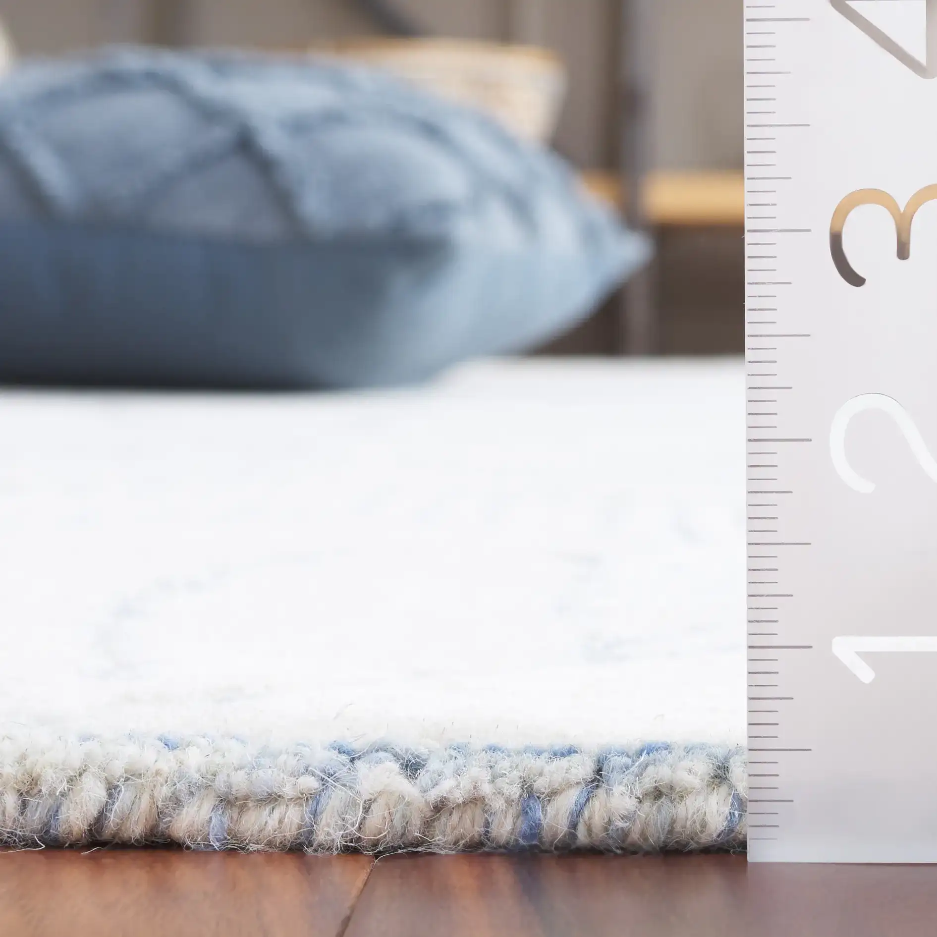 Ebony Leaf Hand-Tufted Wool Rug in Blue / Ivory in a styled room