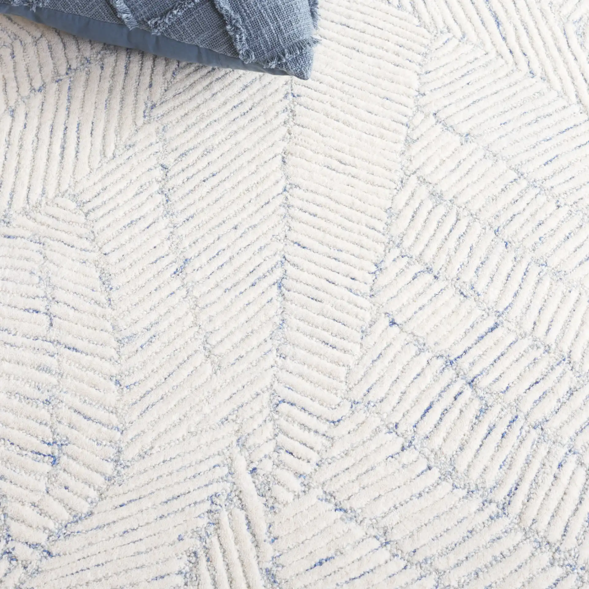 Ebony Leaf Hand-Tufted Wool Rug in Blue / Ivory in a styled room