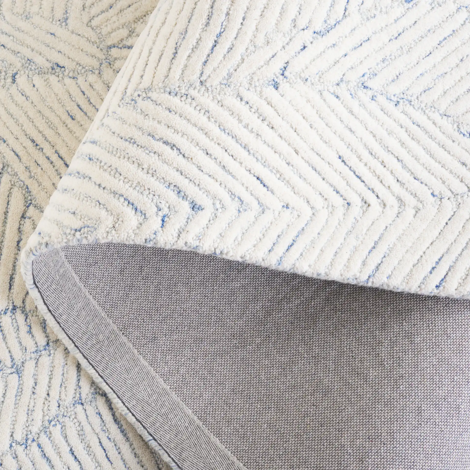 Ebony Leaf Hand-Tufted Wool Rug in Blue / Ivory in a styled room