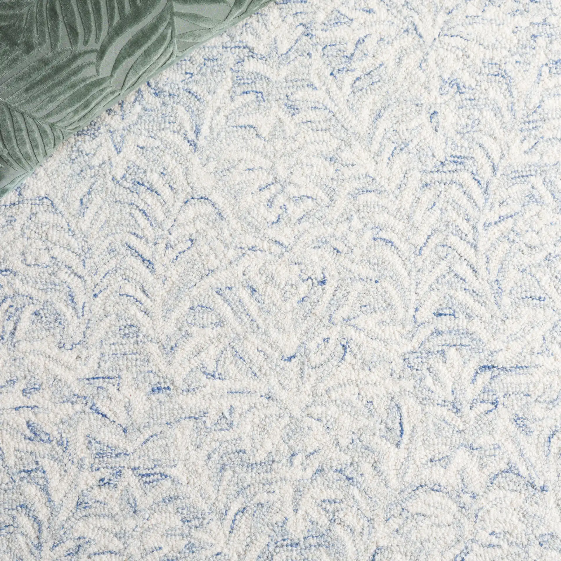 Ebony Leafy Frond Hand-Tufted Wool Rug in Blue / Ivory in a styled room