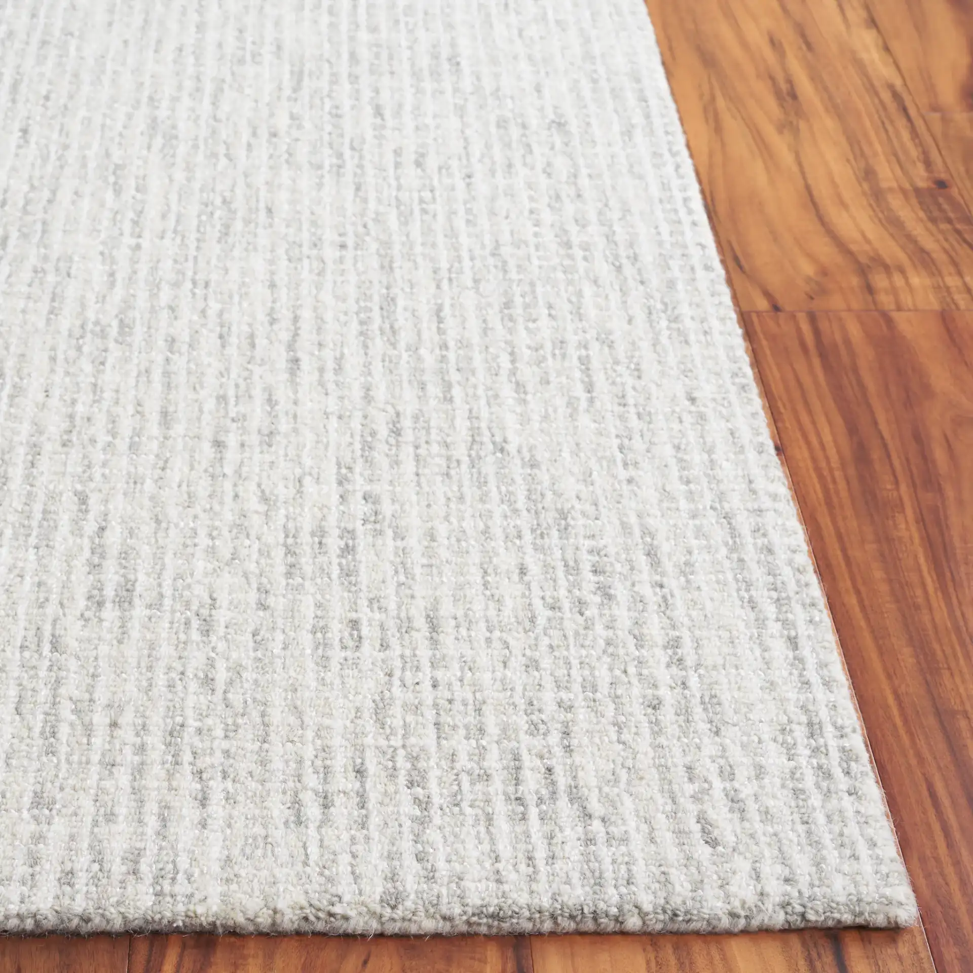 Ebony Linear Grid Hand-Tufted Rug in Gray / Ivory in a styled room