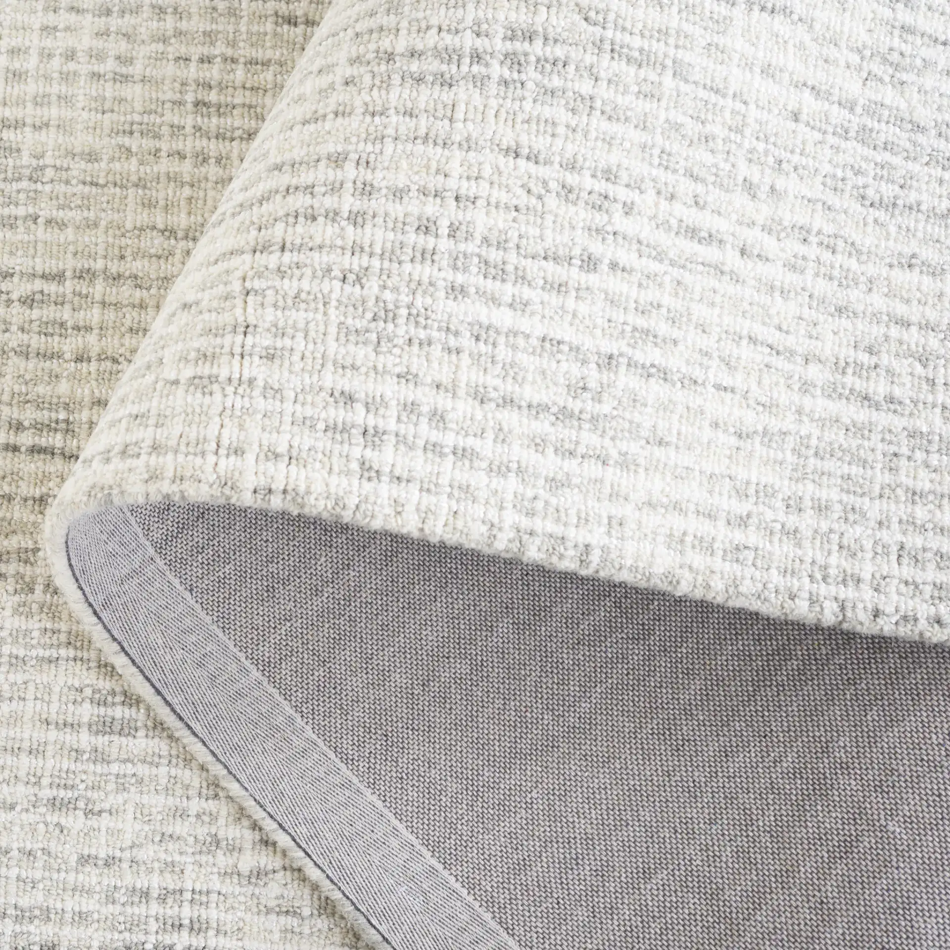 Ebony Linear Grid Hand-Tufted Rug in Gray / Ivory in a styled room