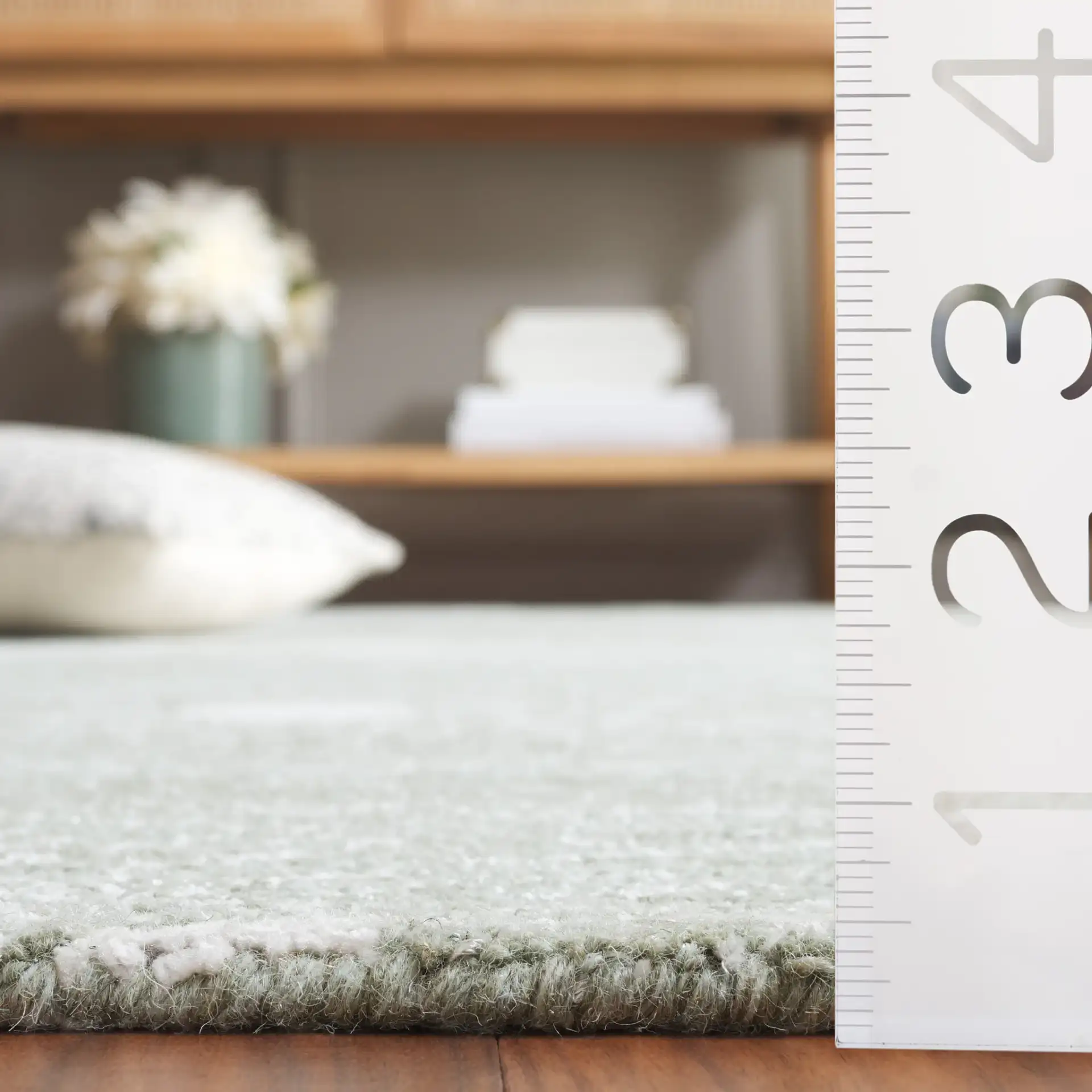 Ebony Swirling Circle Hand-Tufted Rug in Sage / Ivory in a styled room