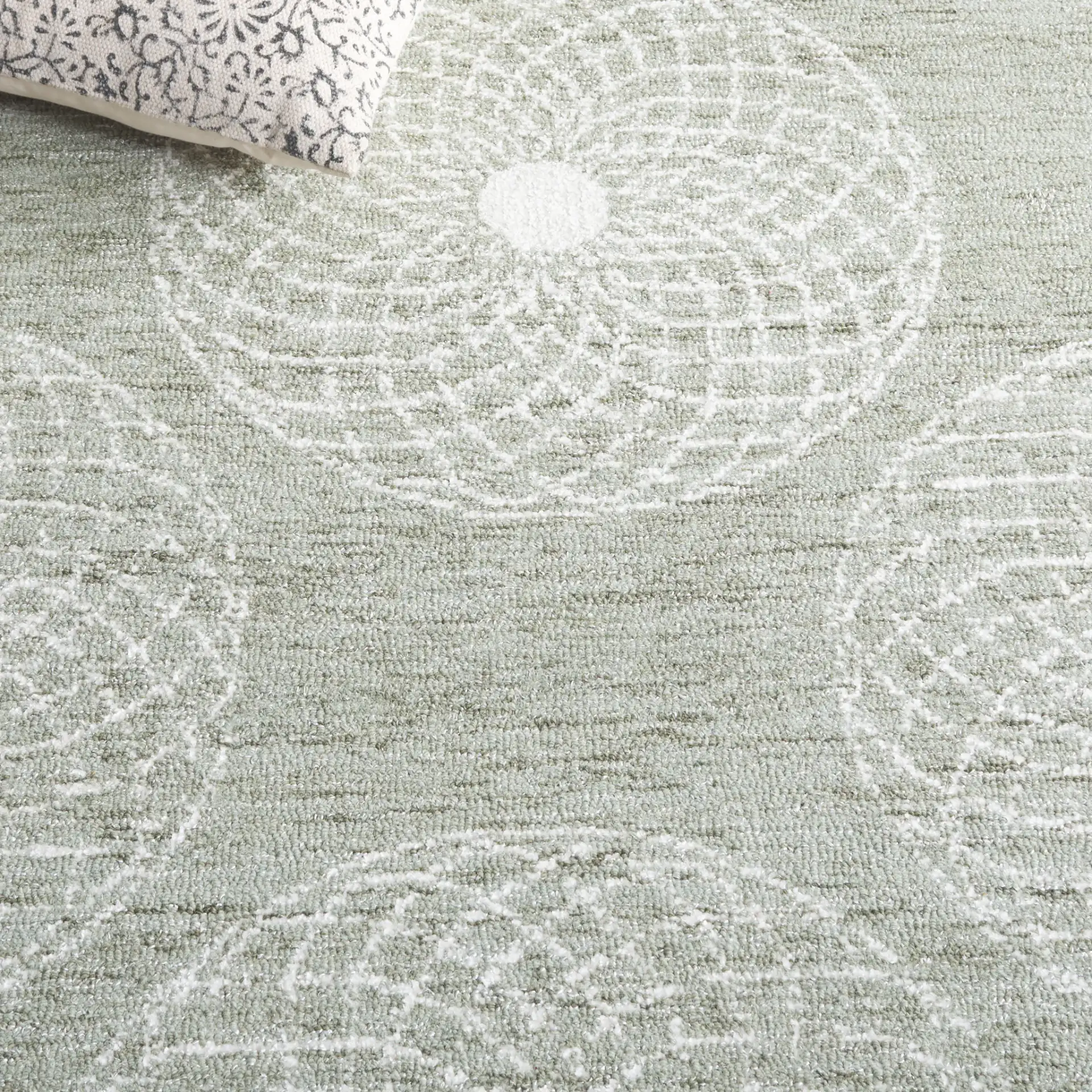 Ebony Swirling Circle Hand-Tufted Rug in Sage / Ivory in a styled room