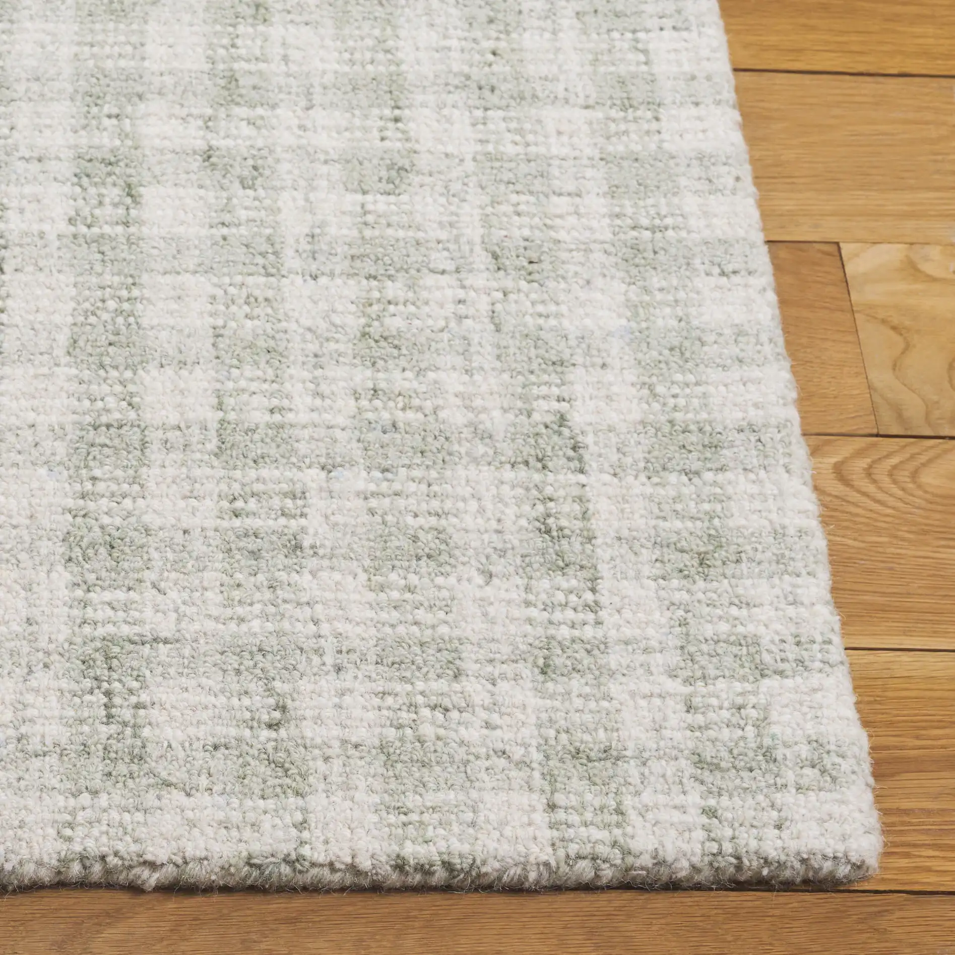 Ebony Checkered Hand-Tufted Wool Rug in Sage / Ivory in a styled room