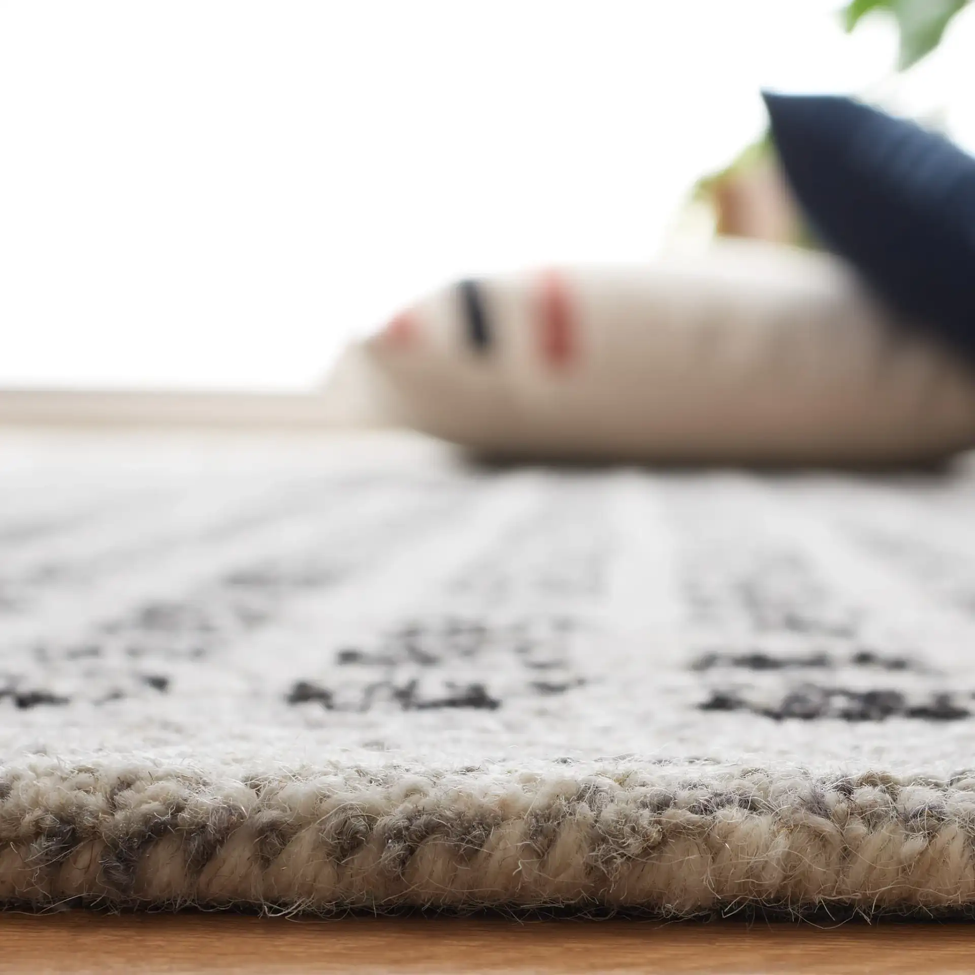 Ebony Dotted Grid Hand-Tufted Wool Rug in Silver / Black in a styled room