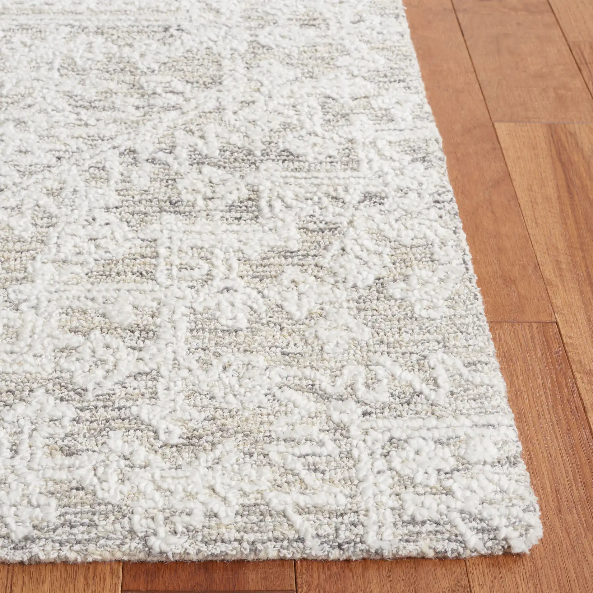 Ebony Medallion Hand-Tufted Rug in Ivory / Silver in a styled room