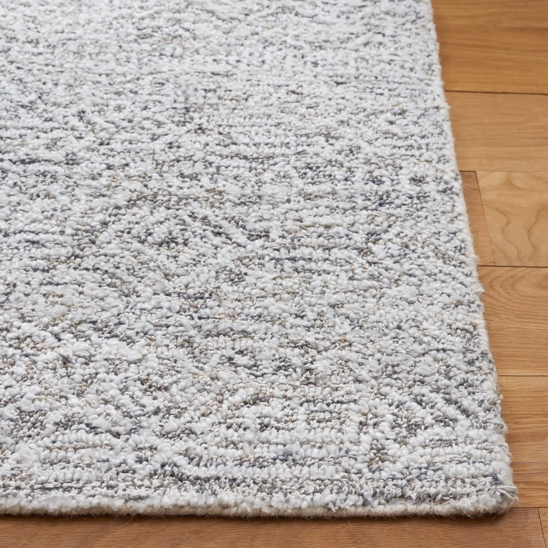 Ebony Patchwork Hand-Tufted Rug in Gray / Ivory in a styled room