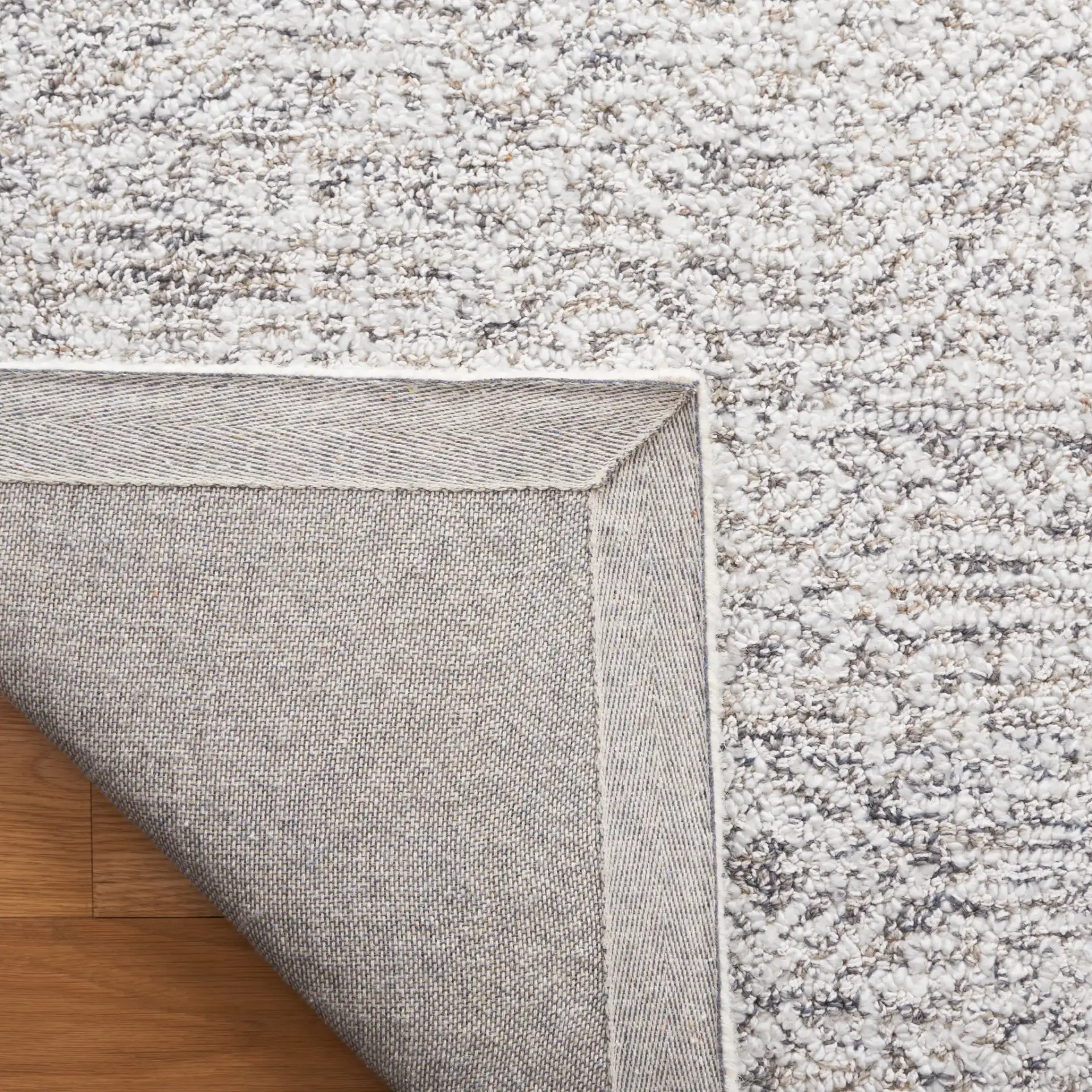 Ebony Patchwork Hand-Tufted Rug in Gray / Ivory in a styled room
