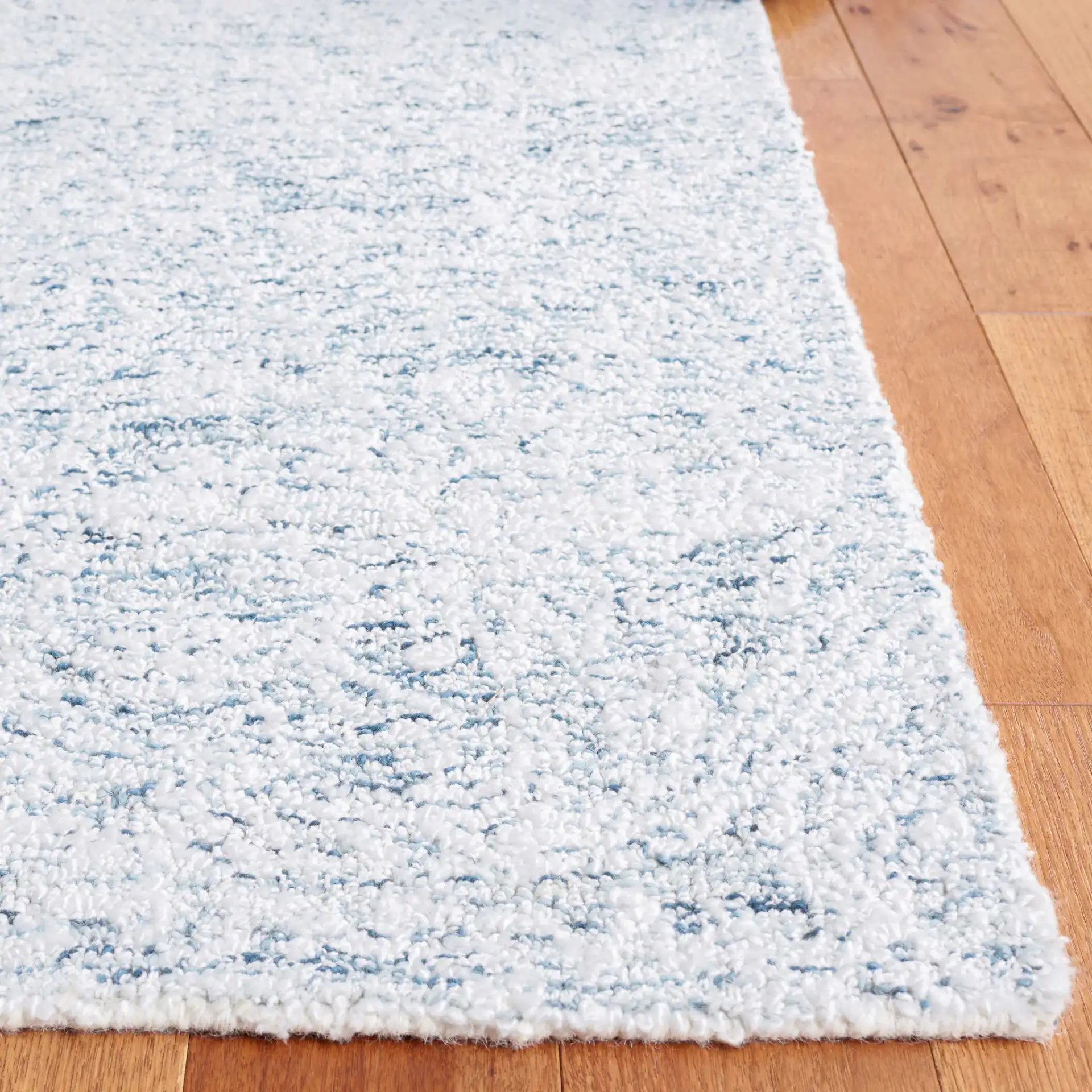 Ebony Erased Damask Hand-Tufted Rug in Light Blue / Ivory in a styled room