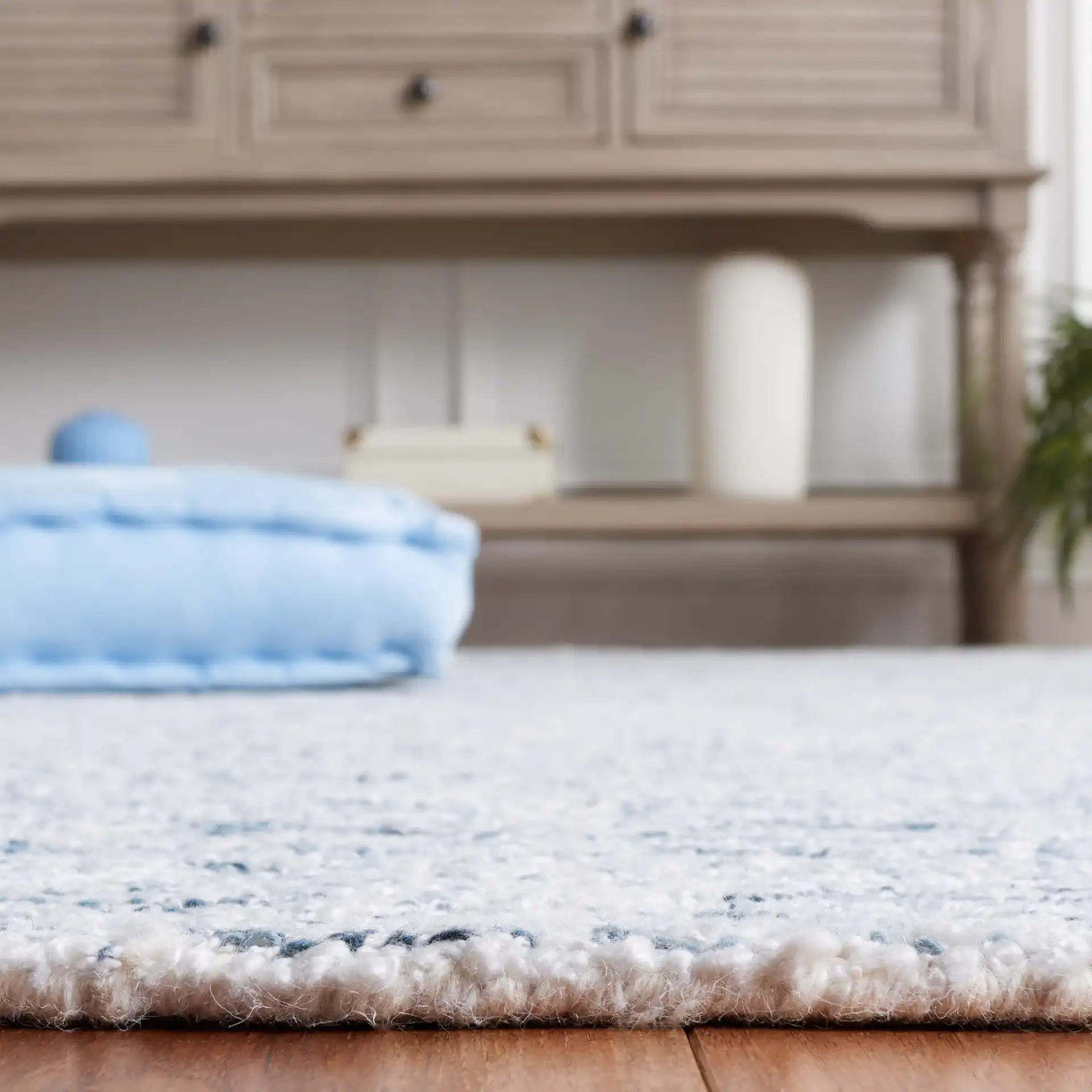 Ebony Erased Damask Hand-Tufted Rug in Light Blue / Ivory in a styled room