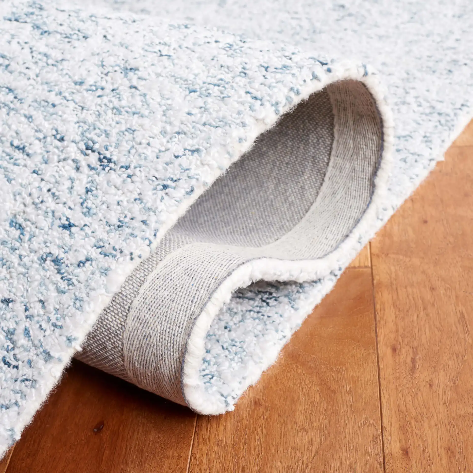 Ebony Erased Damask Hand-Tufted Rug in Light Blue / Ivory in a styled room