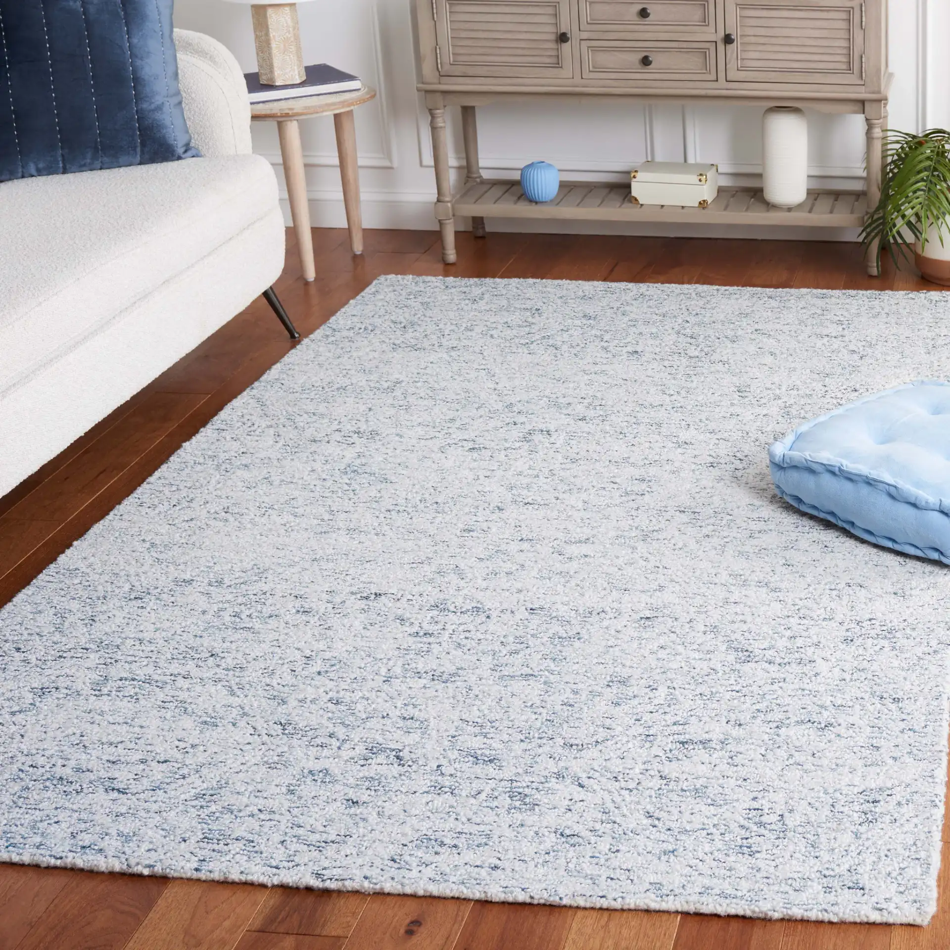 Ebony Erased Damask Hand-Tufted Rug in Light Blue / Ivory in a styled room