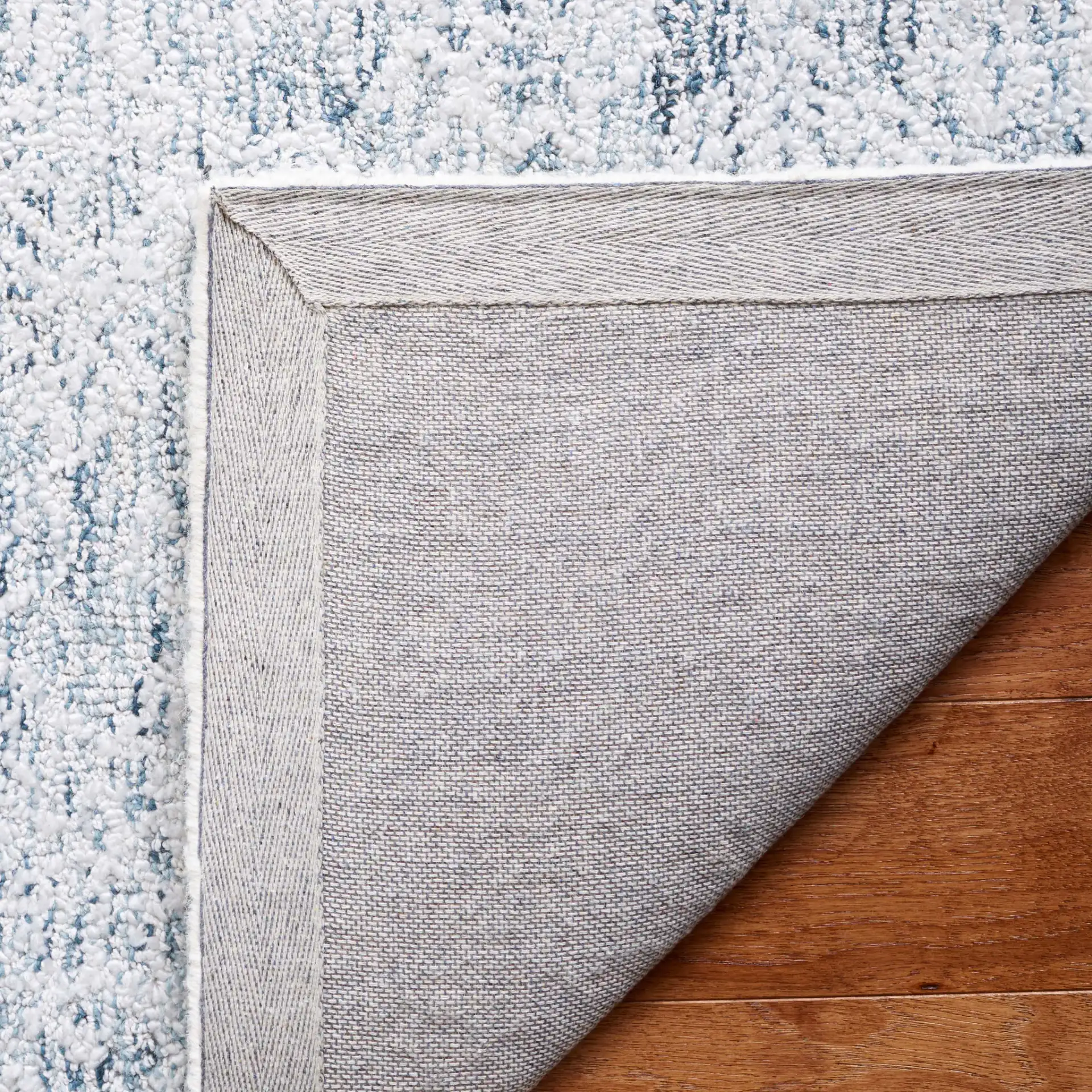 Ebony Erased Damask Hand-Tufted Rug in Light Blue / Ivory in a styled room