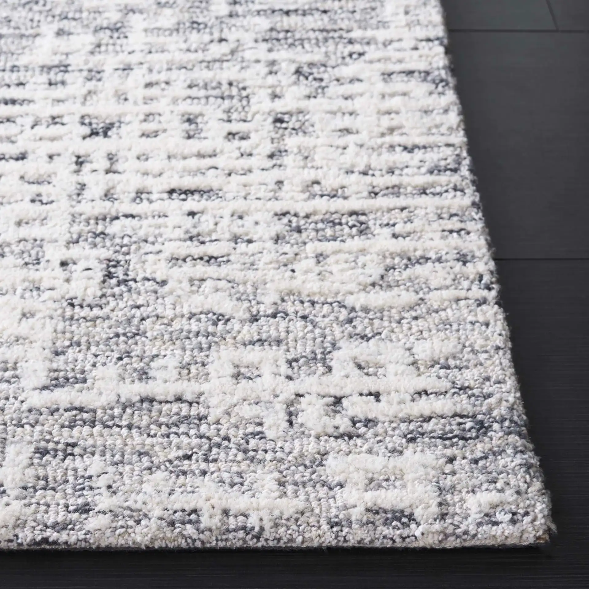 Ebony Distressed Grid Hand-Tufted Wool Rug in Ivory / Gray in a styled room
