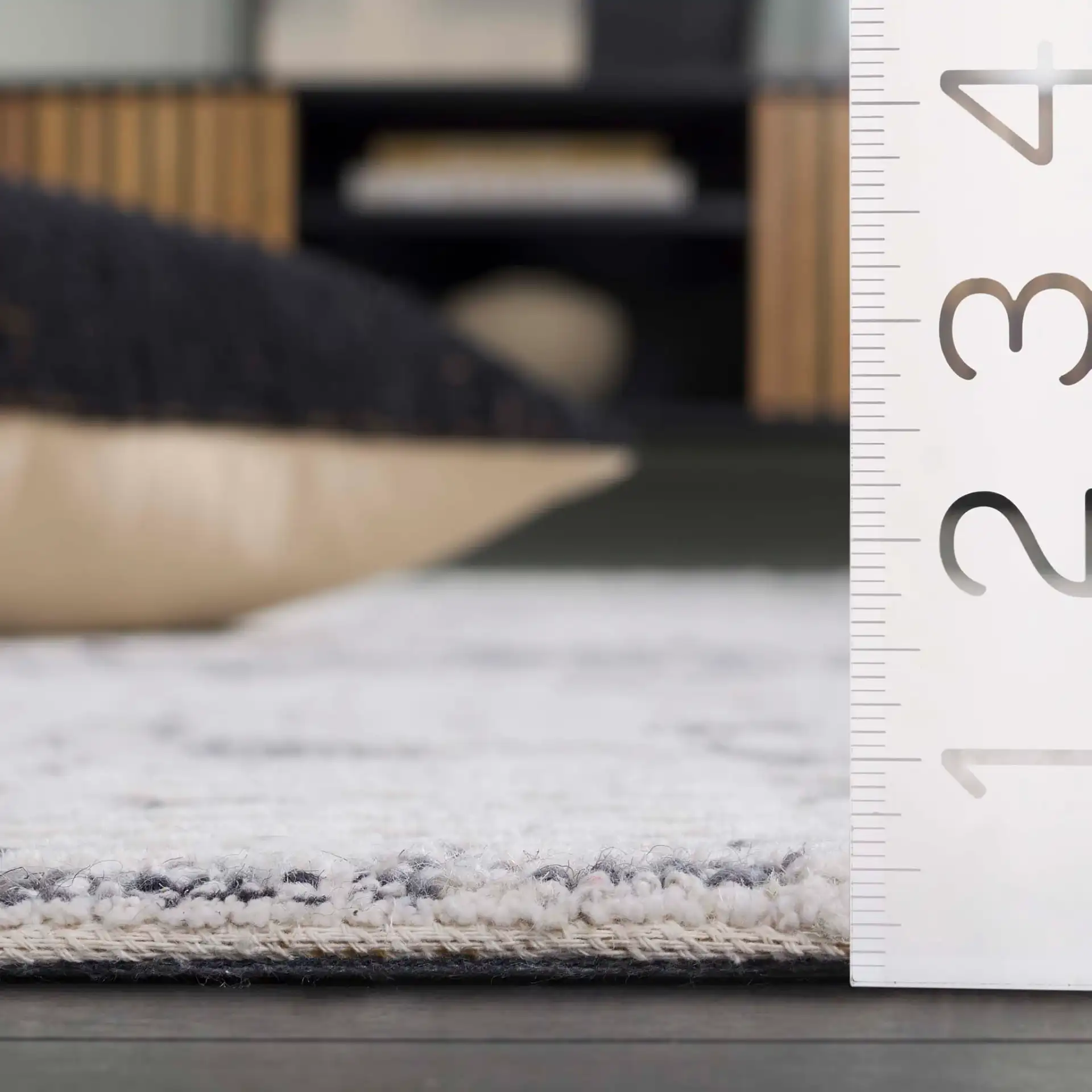 Ebony Distressed Grid Hand-Tufted Wool Rug in Ivory / Gray in a styled room