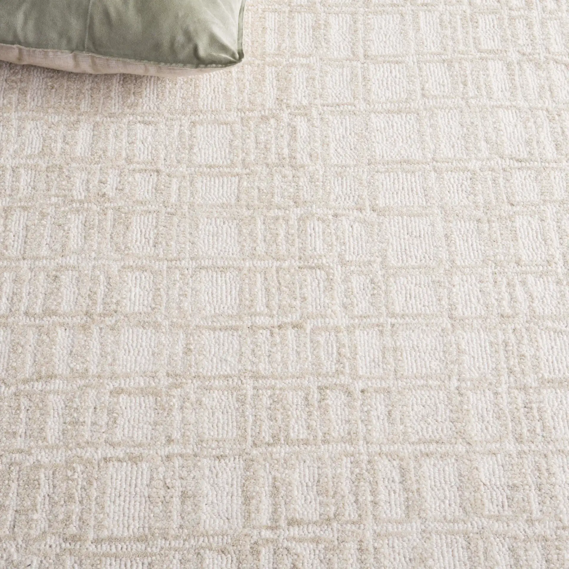 Ebony Bordered Grid Hand-Tufted Wool Rug in Ivory / Beige in a styled room