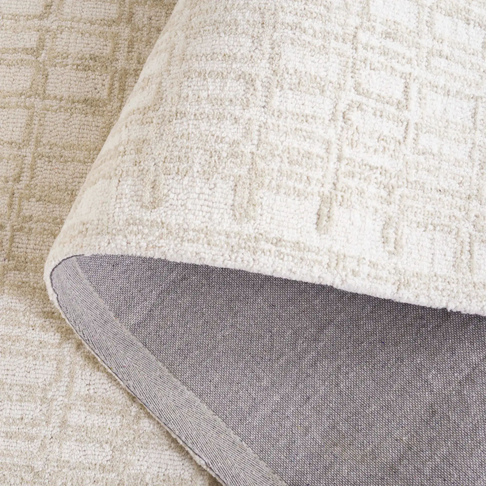 Ebony Bordered Grid Hand-Tufted Wool Rug in Ivory / Beige in a styled room