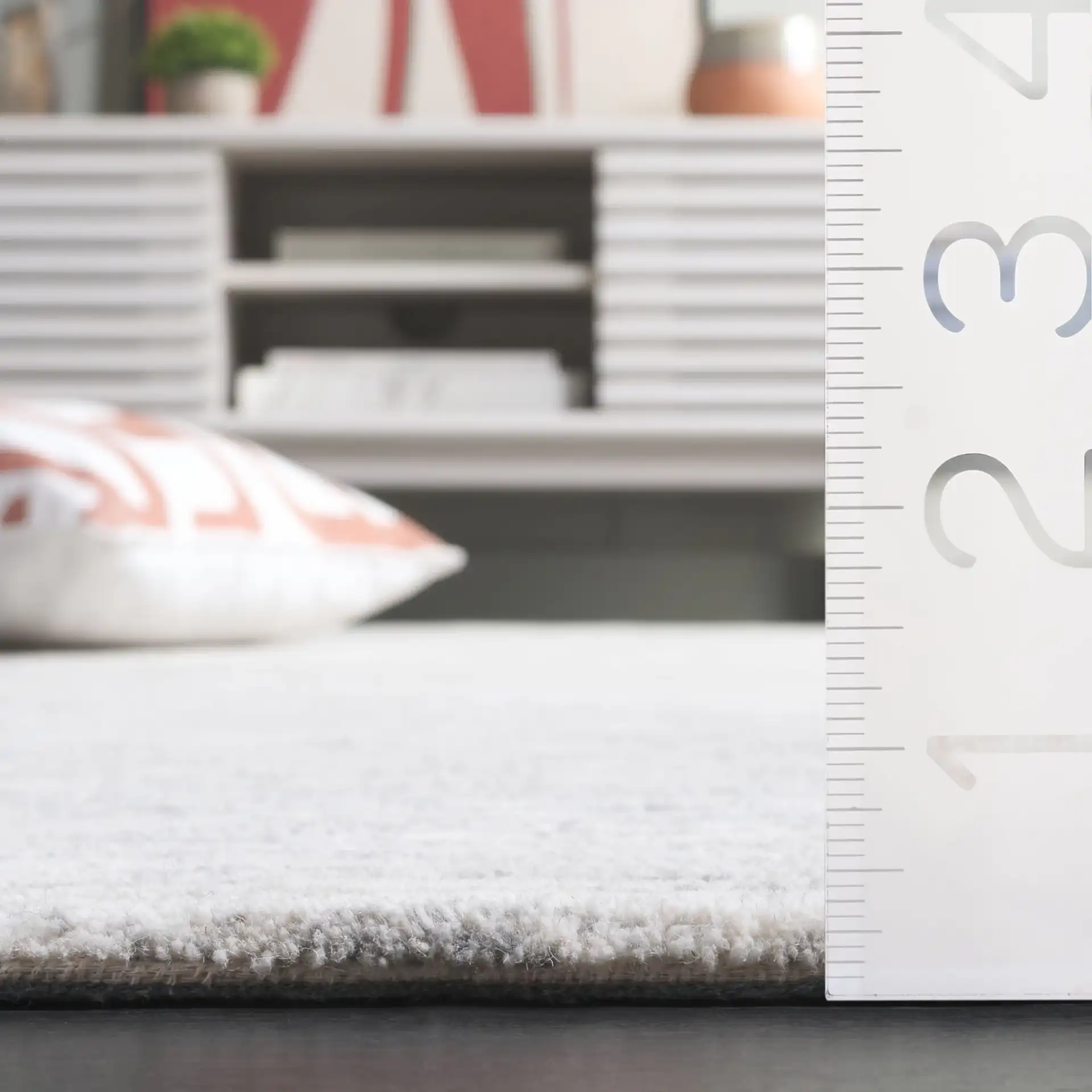Ebony Horizontal Striated Hand-Tufted Wool Rug in Ivory / Dark Gray in a styled room