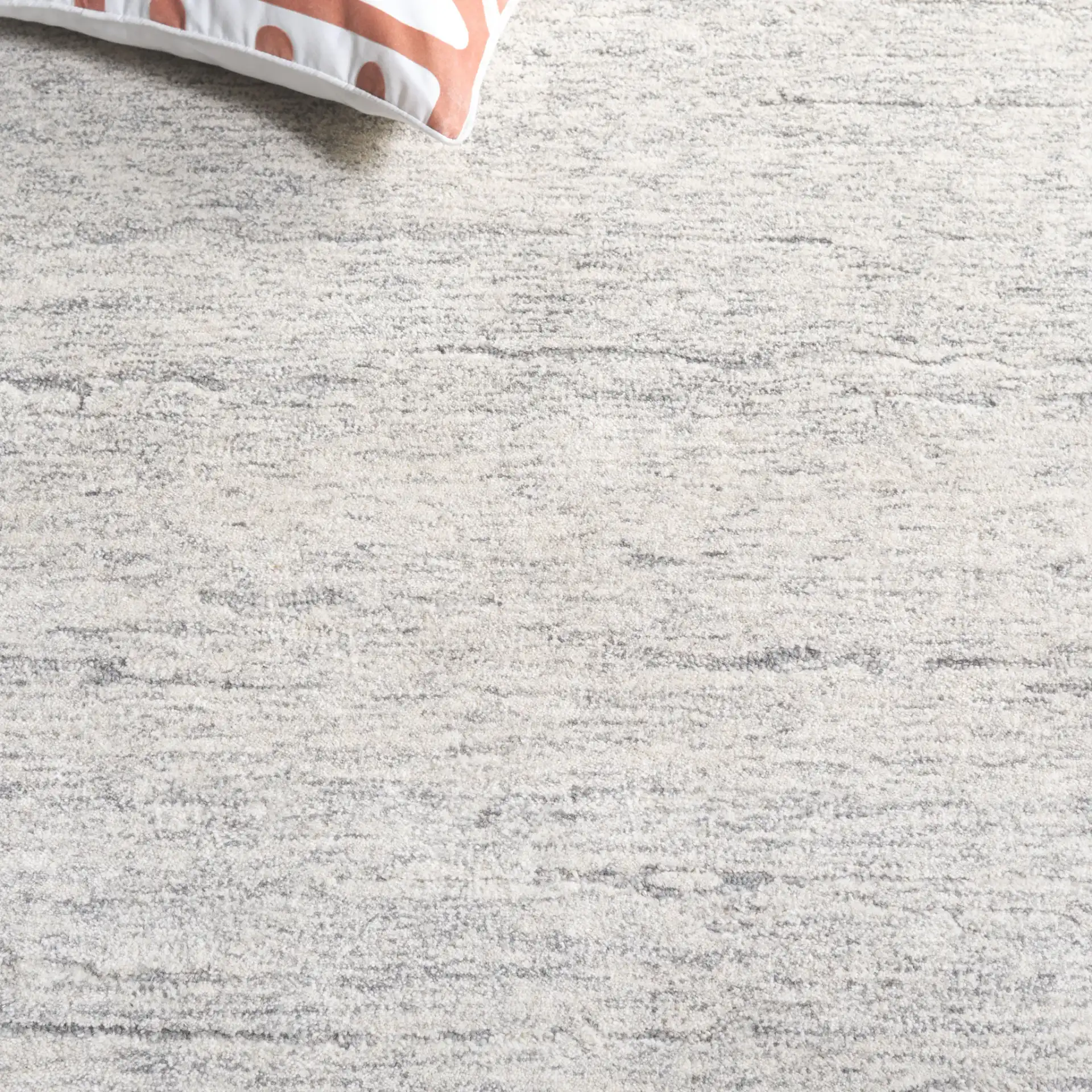 Ebony Horizontal Striated Hand-Tufted Wool Rug in Ivory / Dark Gray in a styled room