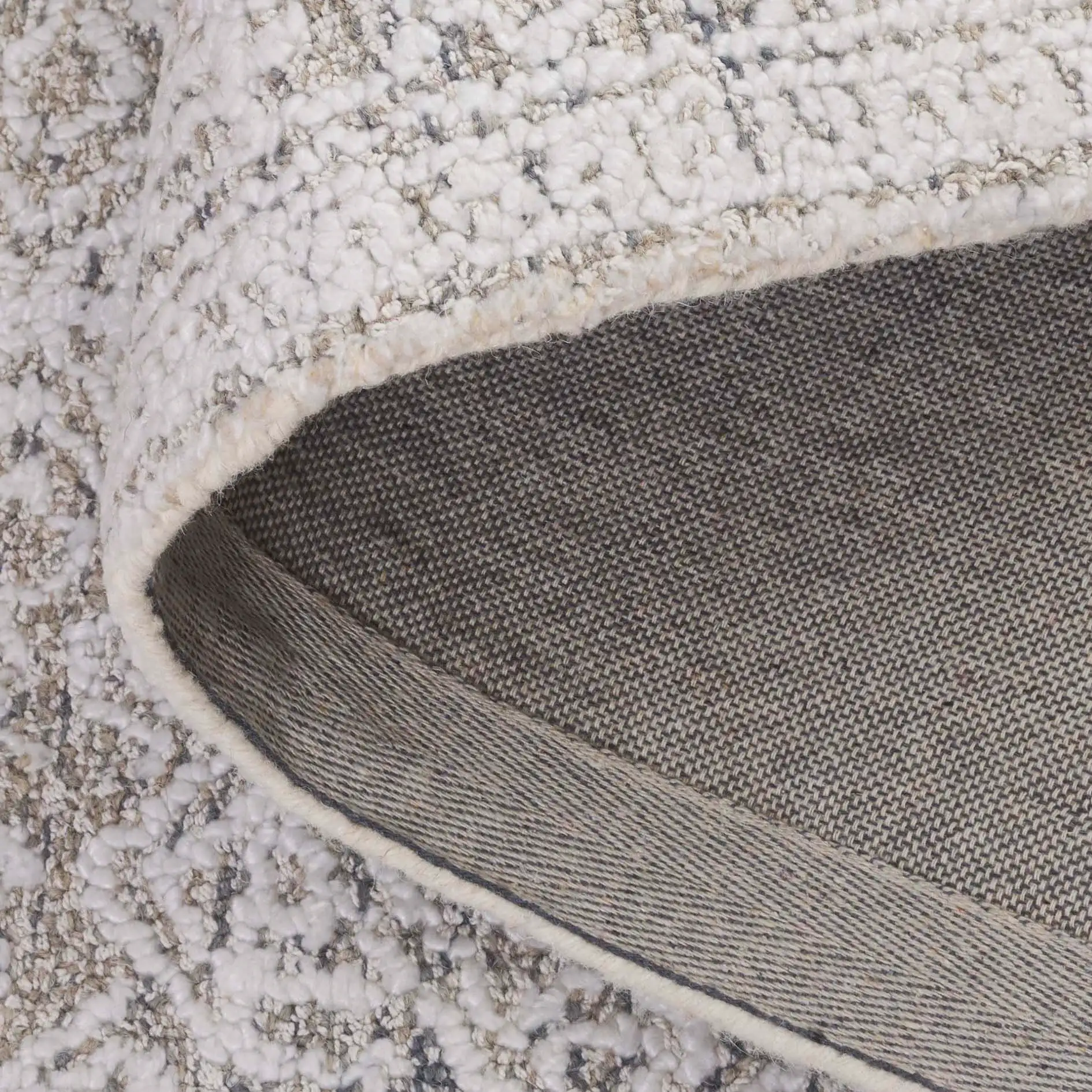Ebony Diamond Bordered Hand-Tufted Rug in Taupe / Ivory in a styled room