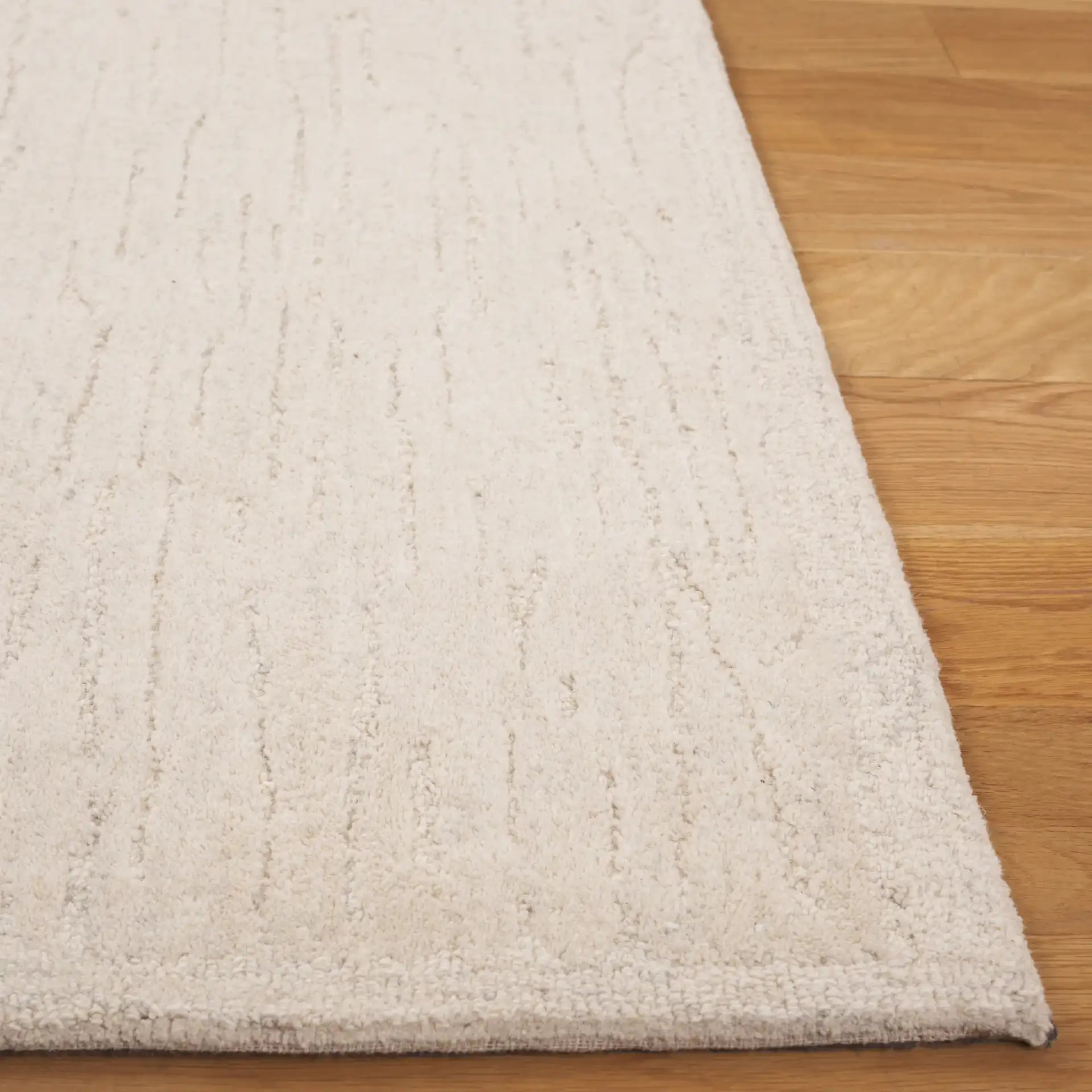 Ebony Linear Striated Hand-Tufted Wool Rug in Green / Ivory in a styled room