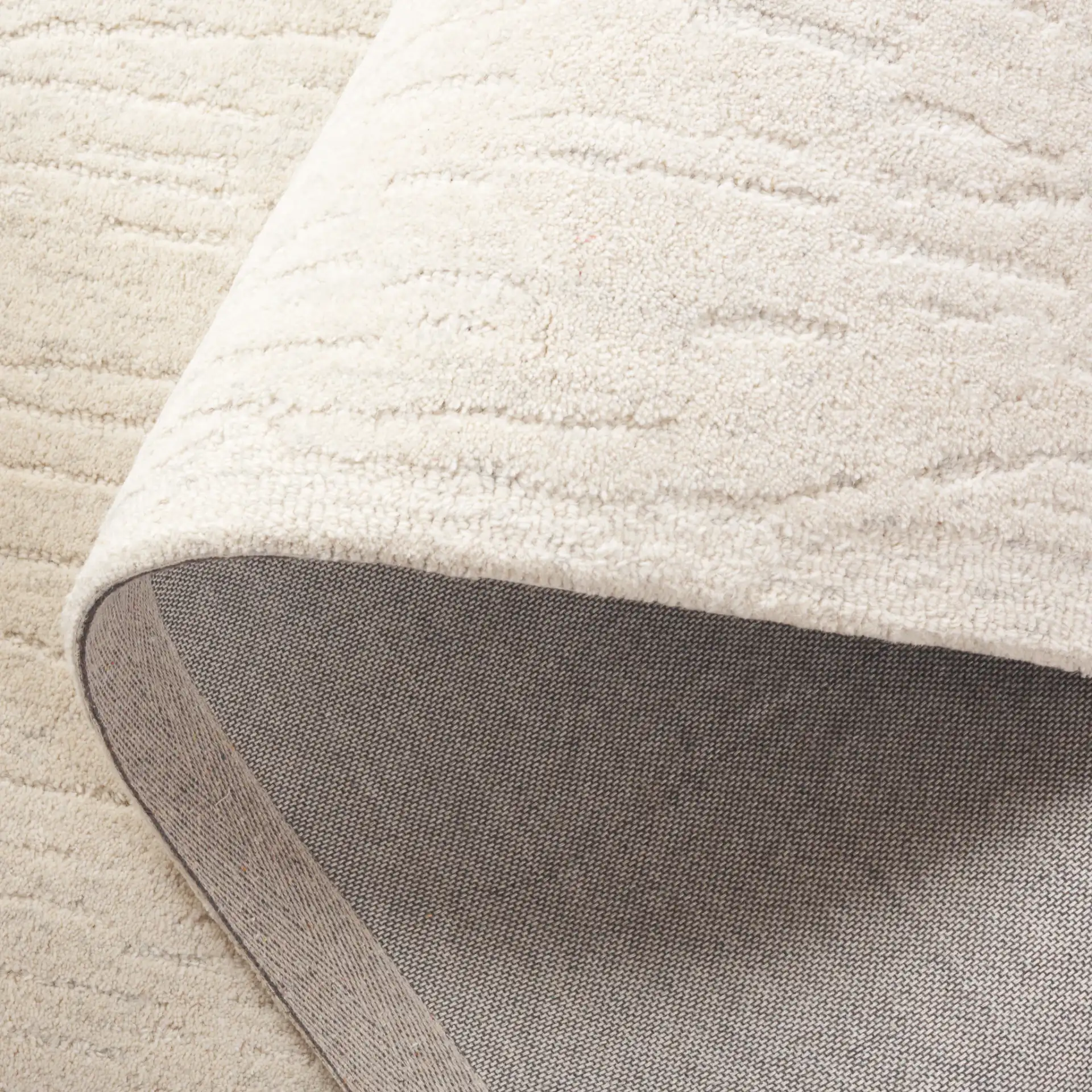 Ebony Linear Striated Hand-Tufted Wool Rug in Green / Ivory in a styled room