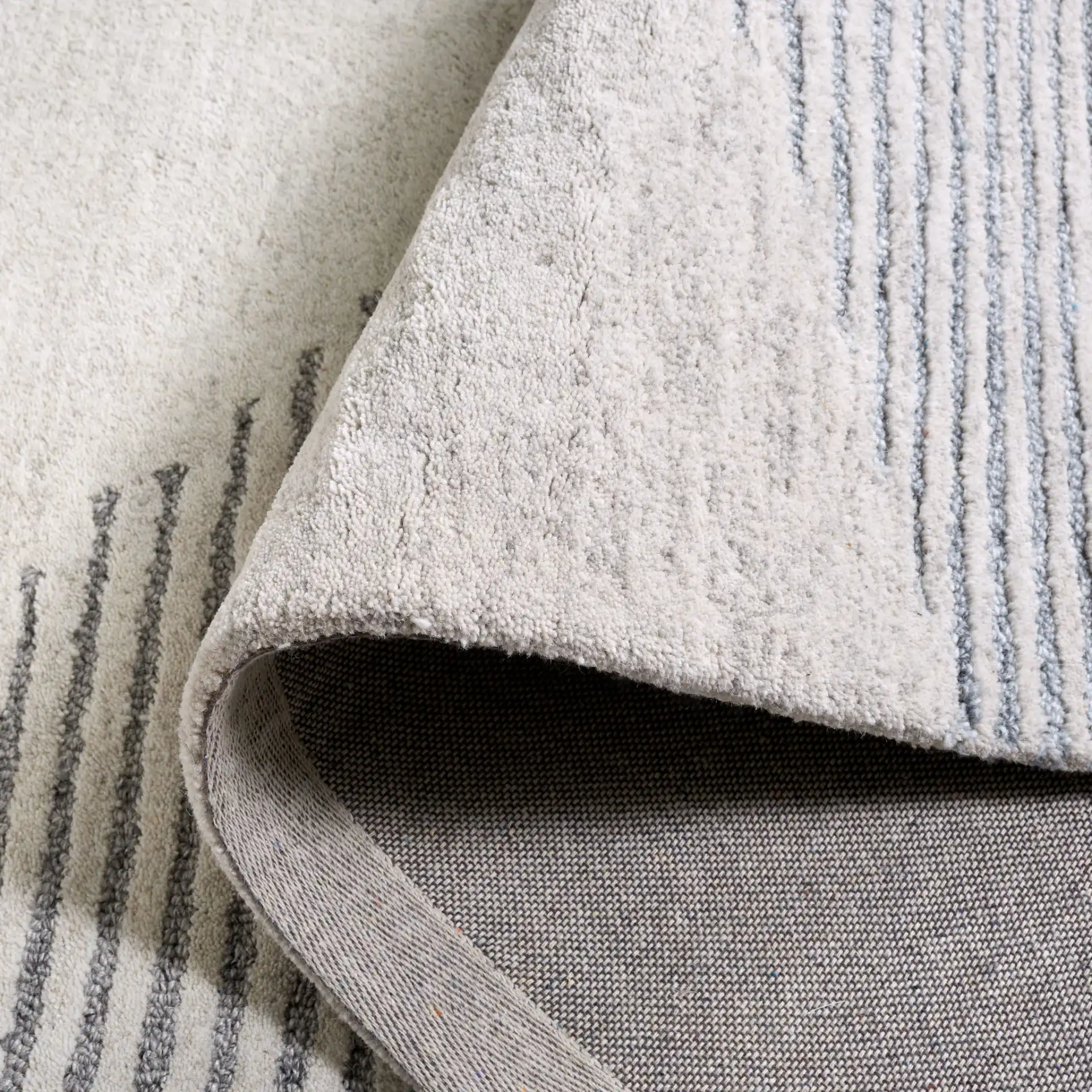 Ebony Linear Block Hand-Tufted Rug in Beige / Gray in a styled room