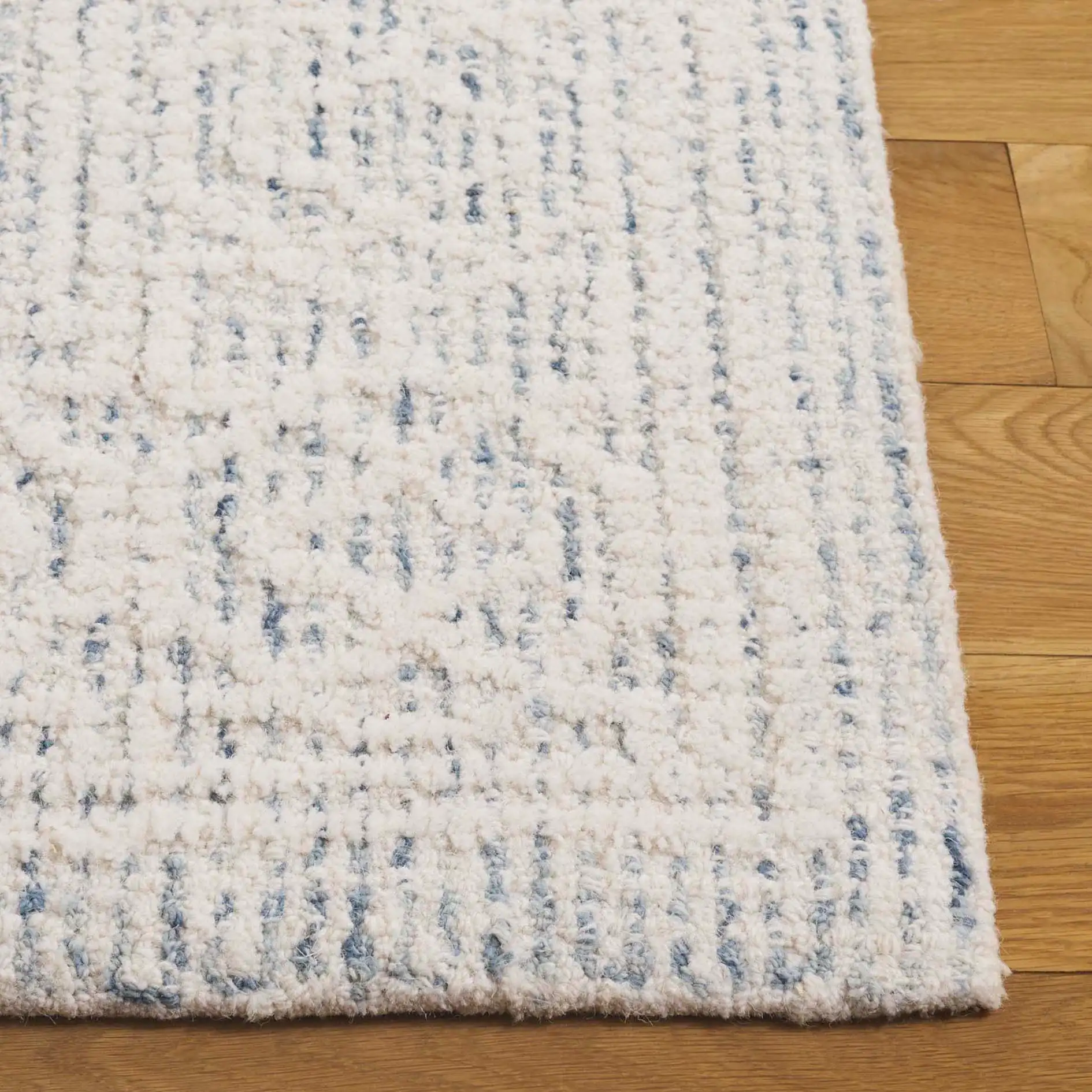 Ebony Plaid Bordered Hand-Tufted Wool Rug in Ivory / Blue in a styled room