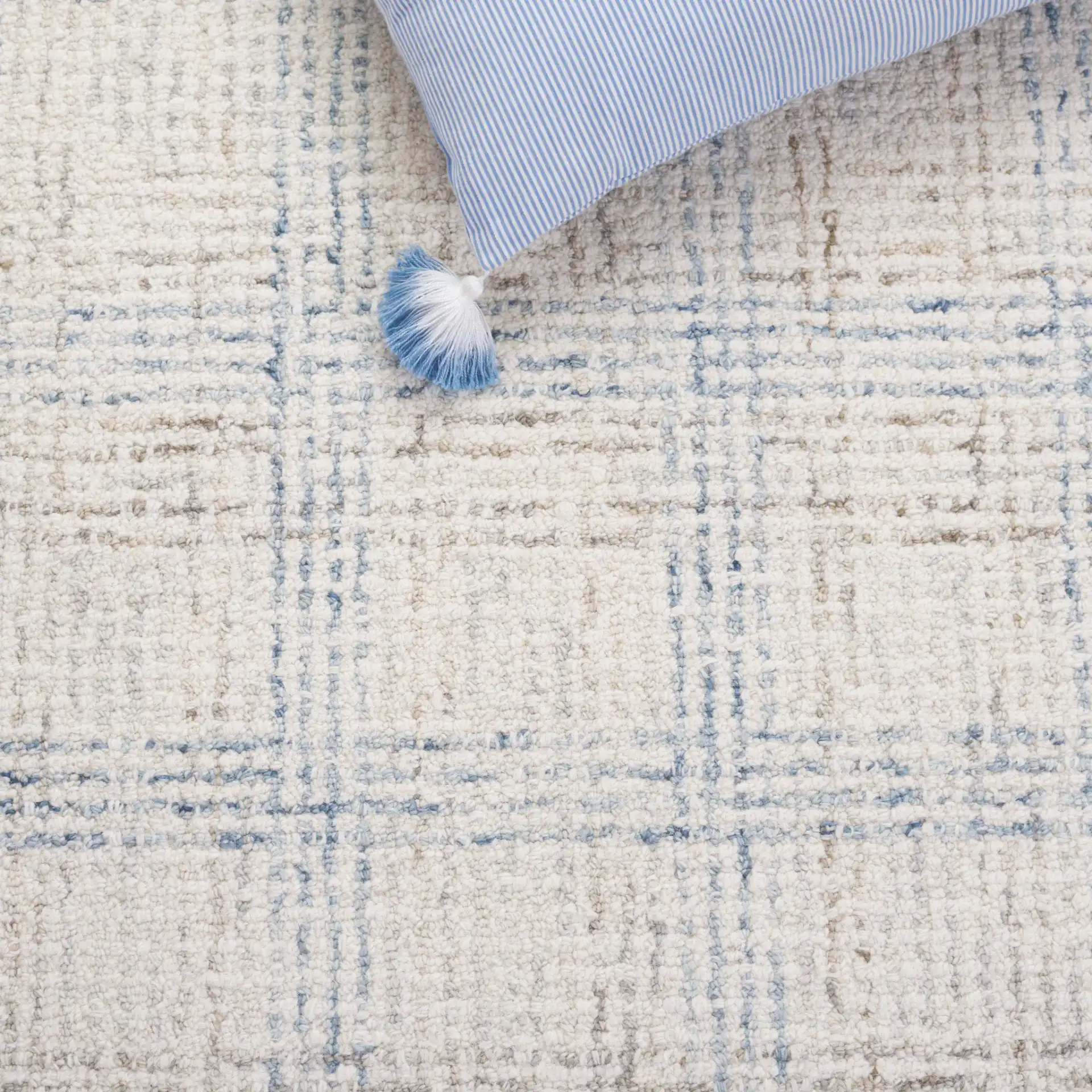 Ebony Plaid Bordered Hand-Tufted Wool Rug in Ivory / Blue in a styled room