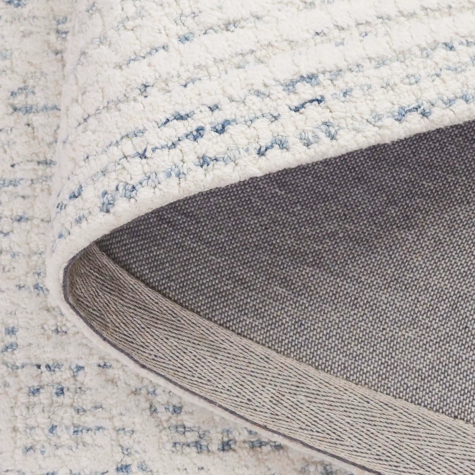 Ebony Plaid Bordered Hand-Tufted Wool Rug in Ivory / Blue in a styled room