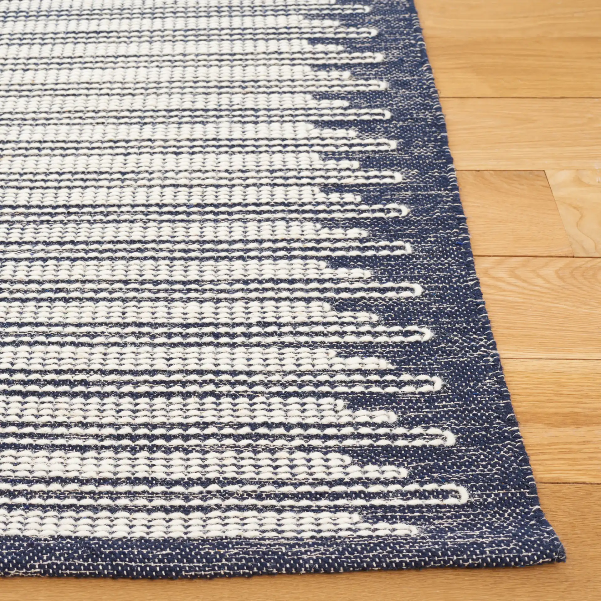 Ebony Striped Border Flatweave Wool Rug in Ivory / Navy in a styled room