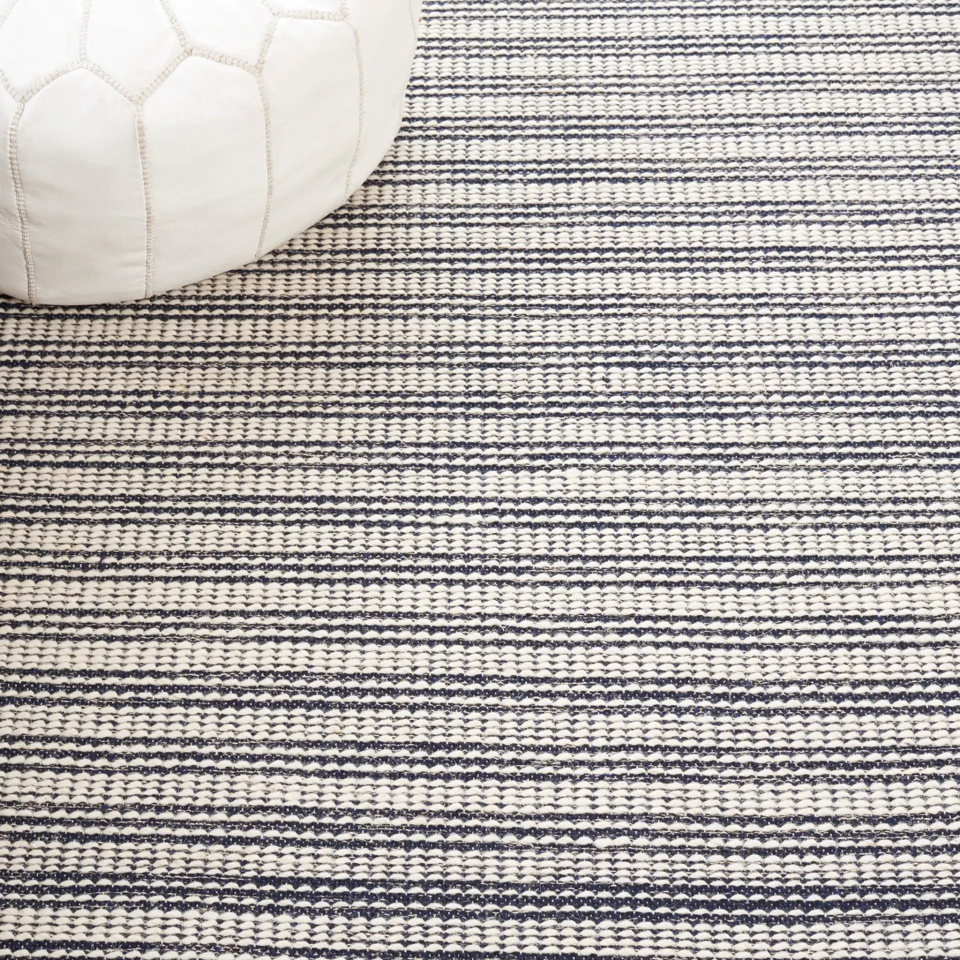 Ebony Striped Border Flatweave Wool Rug in Ivory / Navy in a styled room