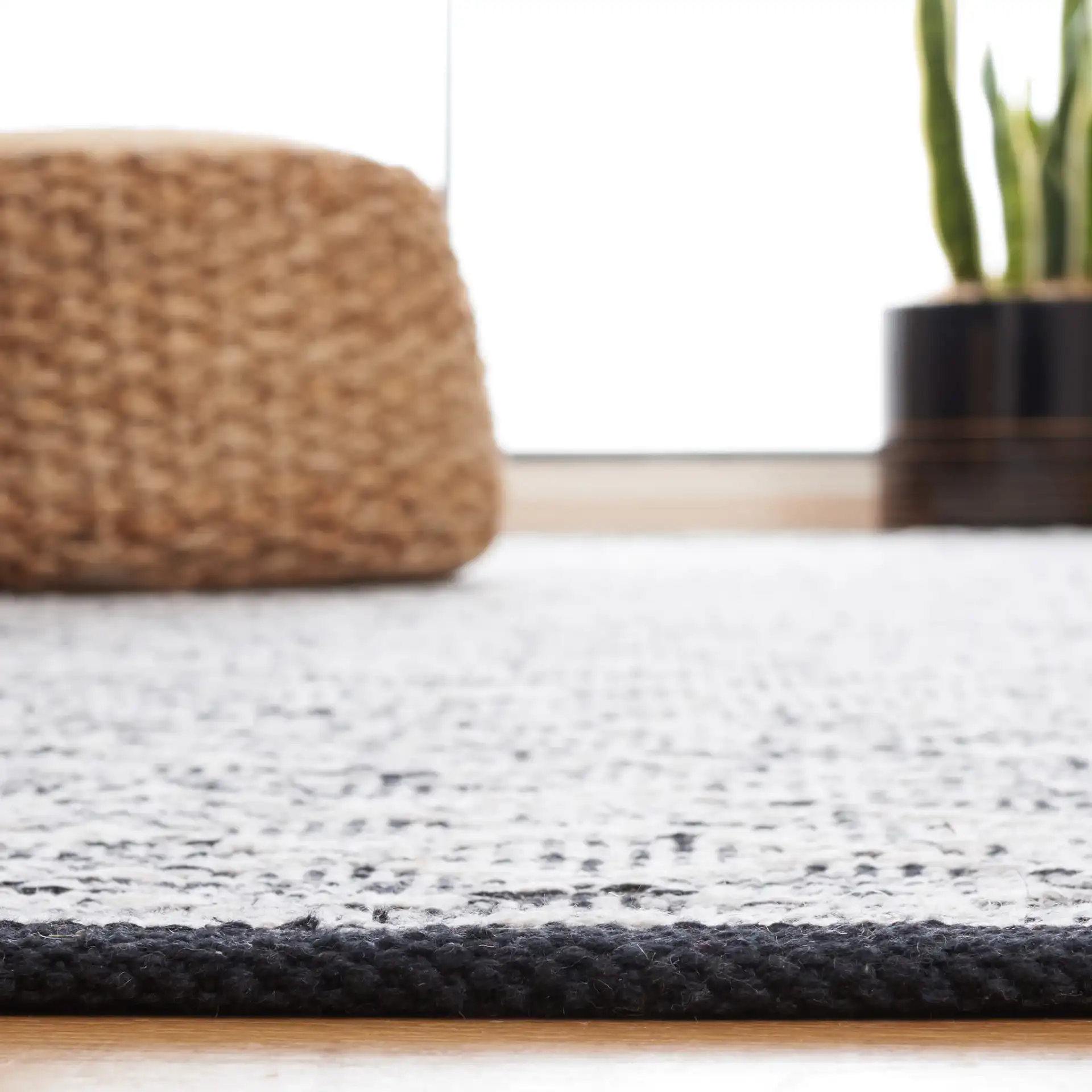 Ebony Diamond Flatweave Cotton Rug in Ivory / Black in a styled room