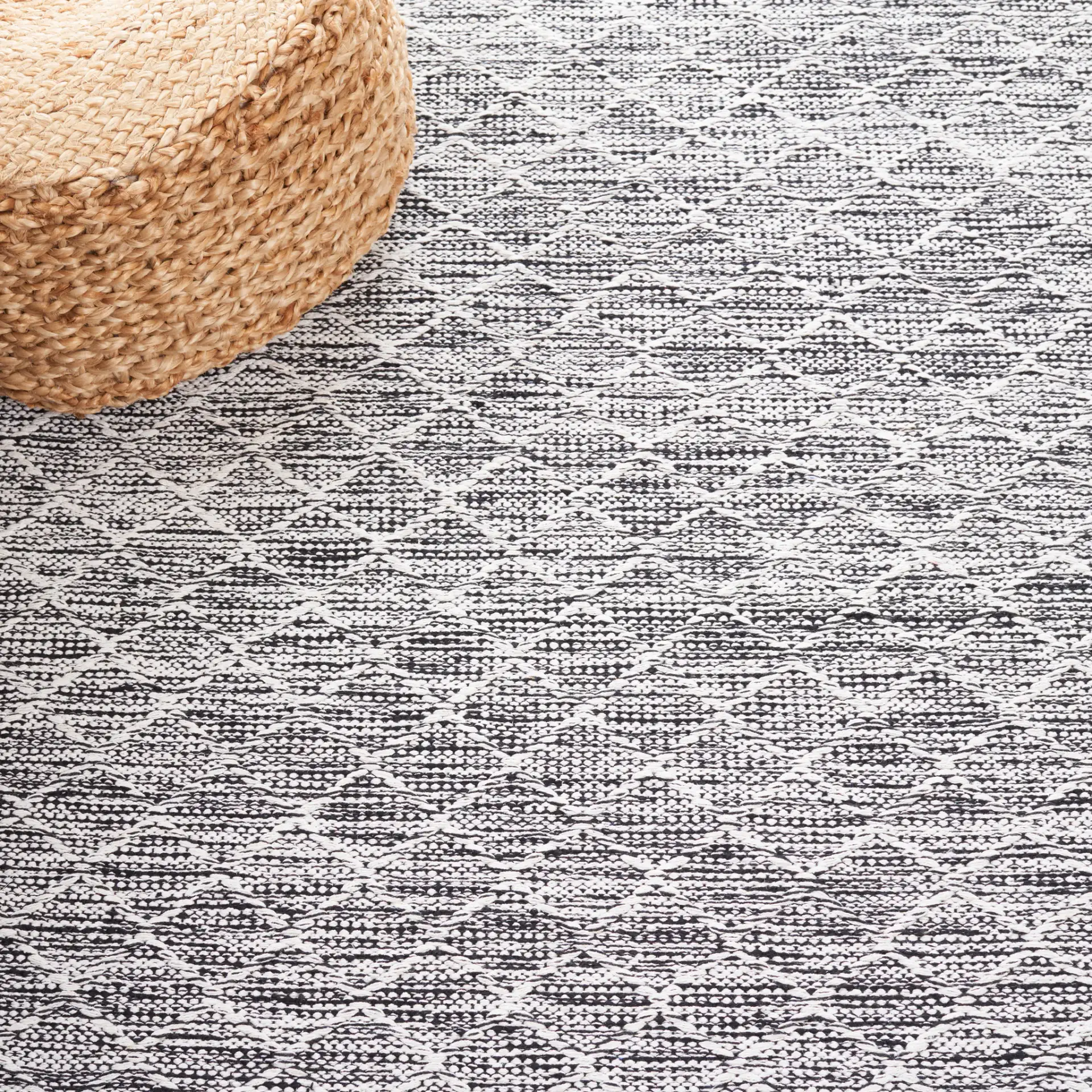 Ebony Diamond Flatweave Cotton Rug in Ivory / Black in a styled room