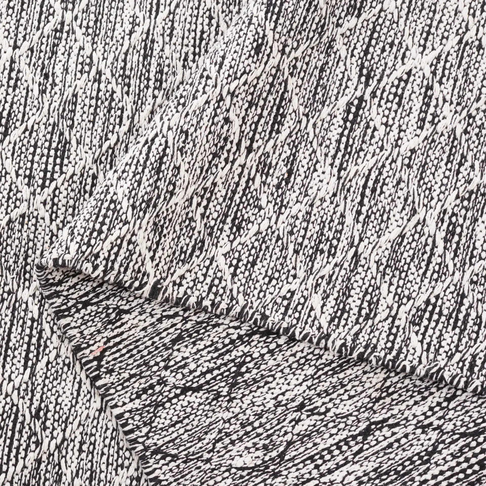 Ebony Diamond Flatweave Cotton Rug in Ivory / Black in a styled room