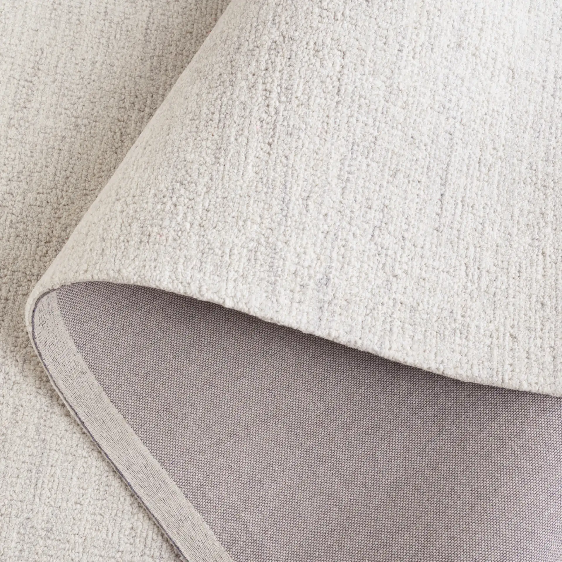 Ebony Solid Hand-Tufted Wool Rug in Light Gray / Ivory in a styled room