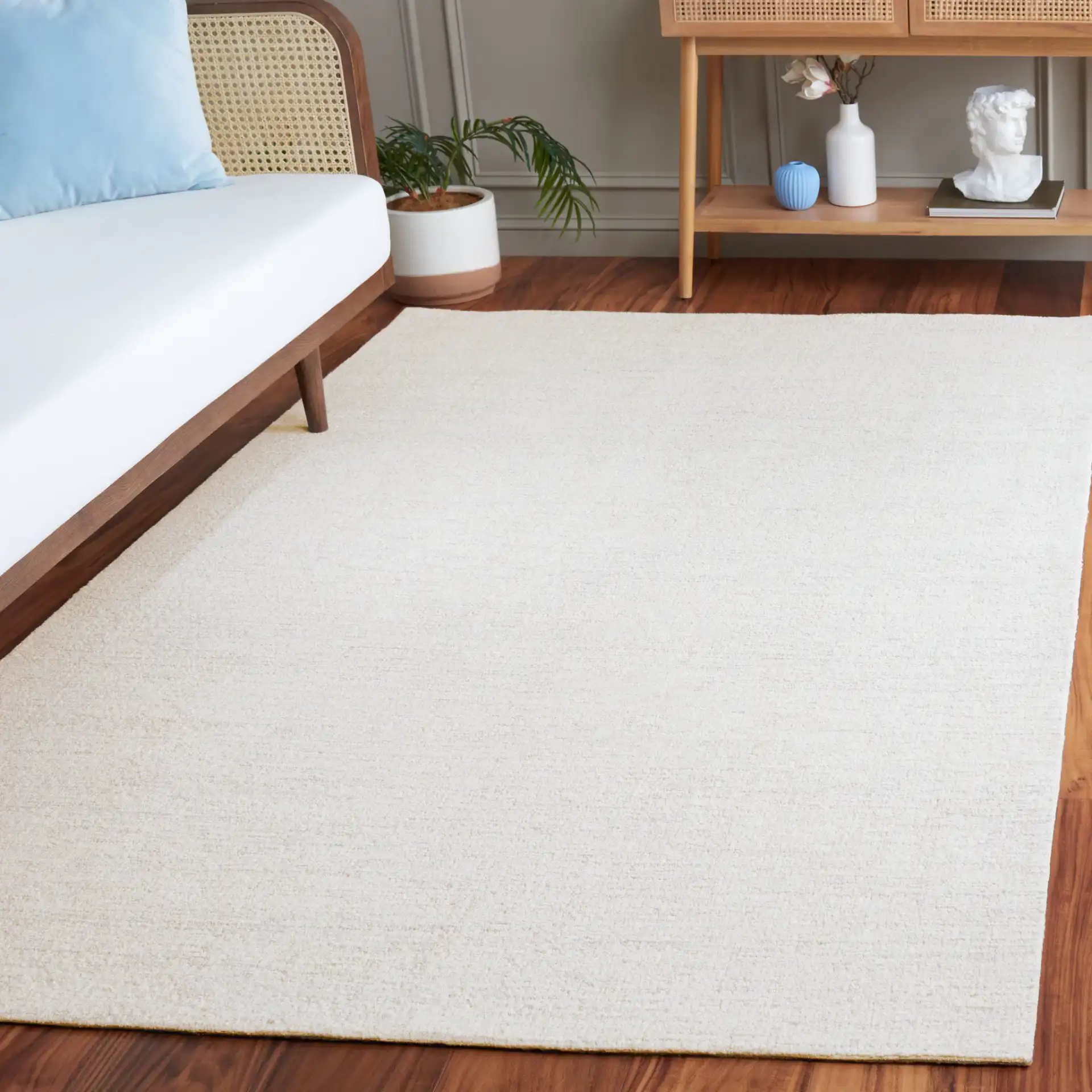Ebony Solid Hand-Tufted Wool Rug in Light Gray / Ivory in a styled room