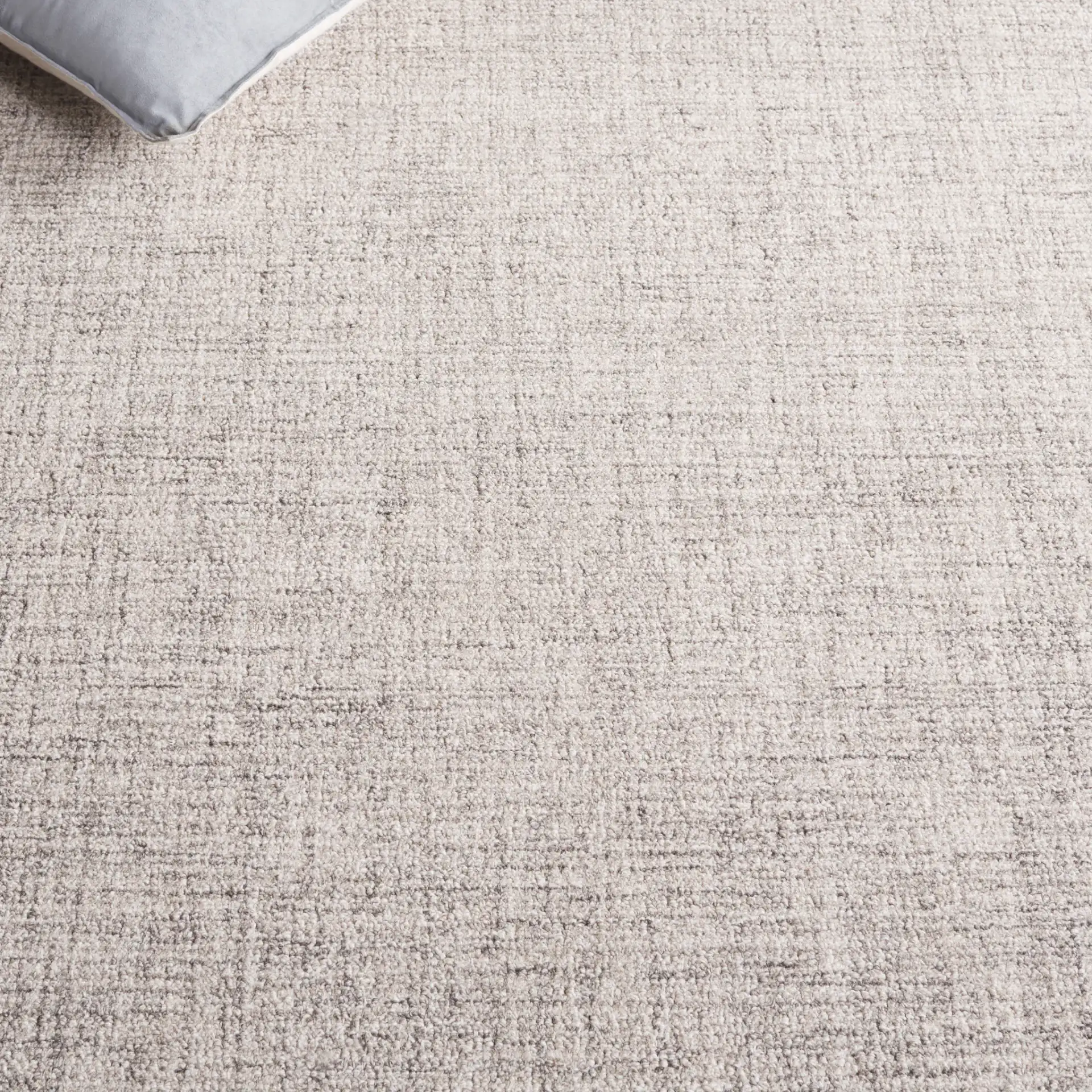 Ebony Concentric Border Hand-Tufted Wool Rug in Gray / Ivory in a styled room