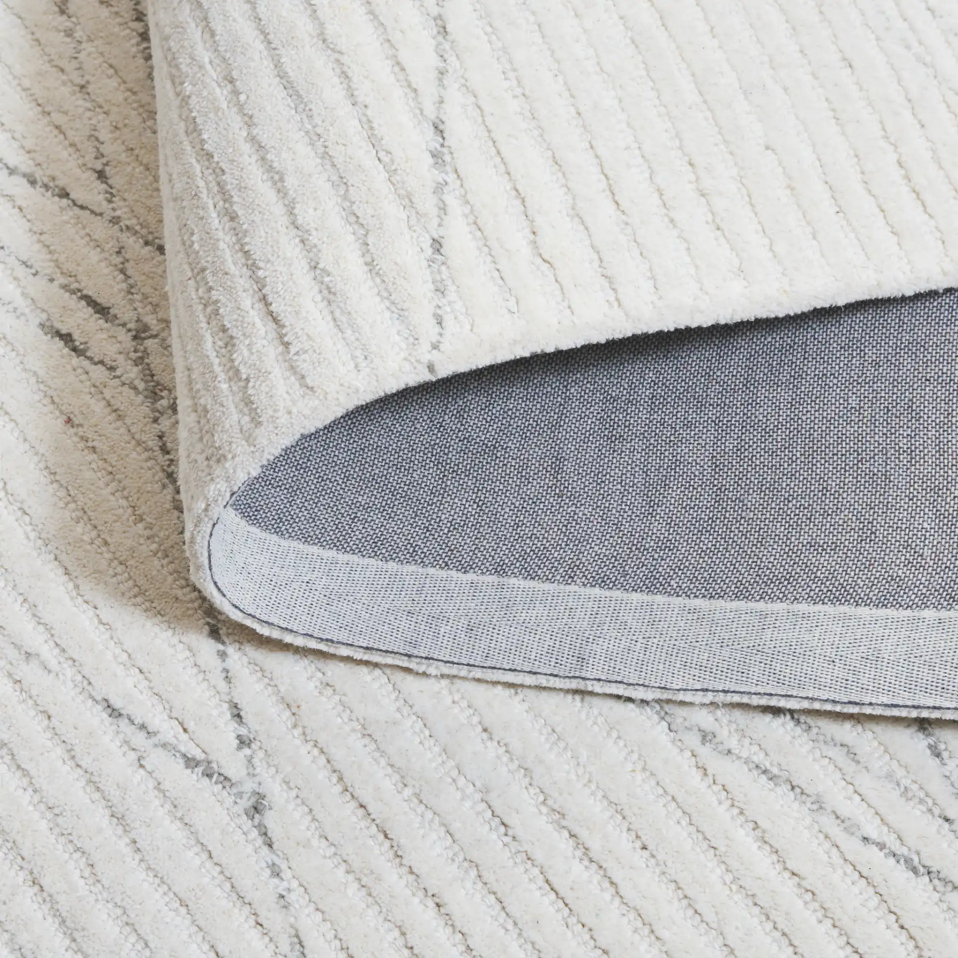 Ebony Linear Hand-Tufted Wool Rug in Ivory / Gray in a styled room