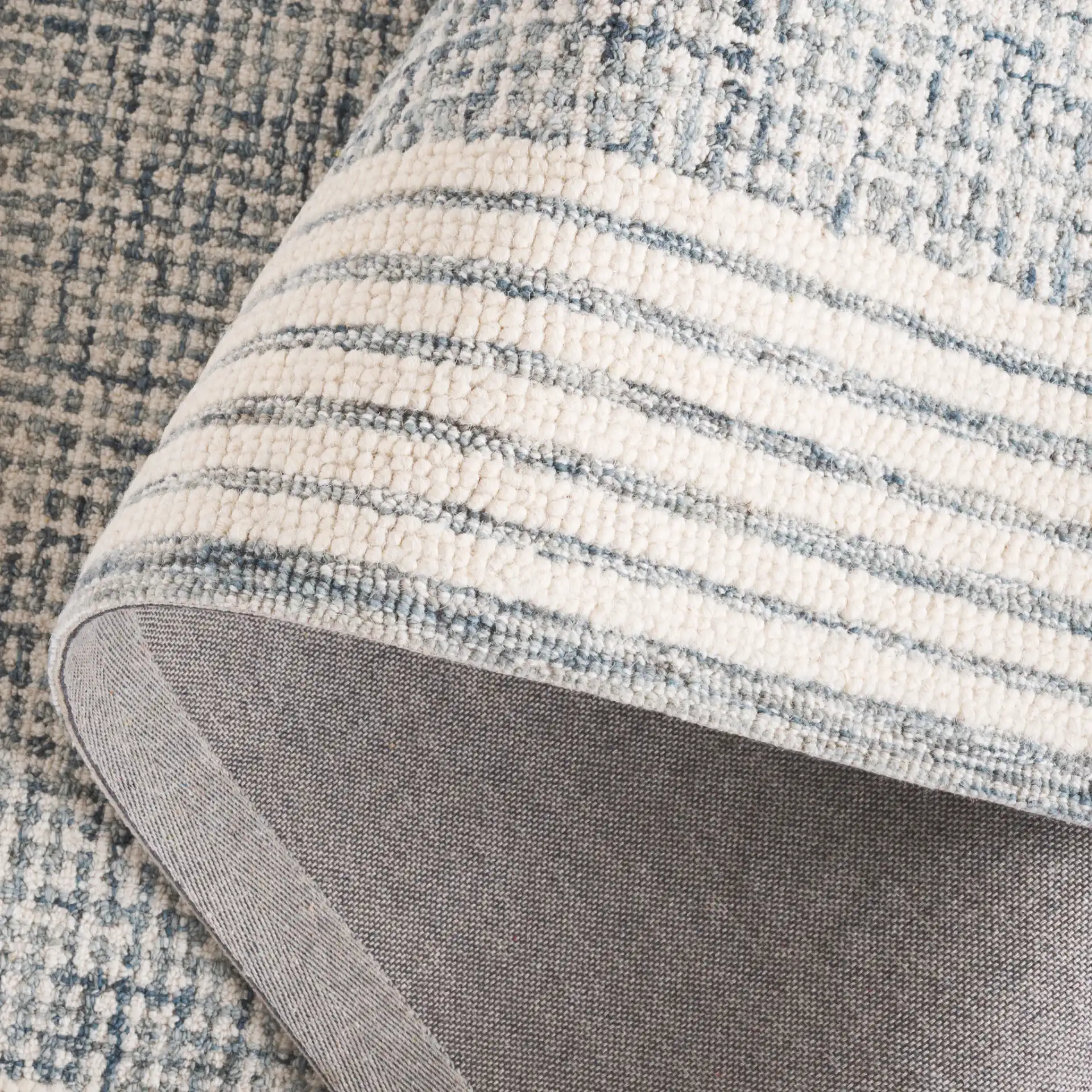 Ebony Grid Border Hand-Tufted Wool Rug in Blue / Ivory in a styled room