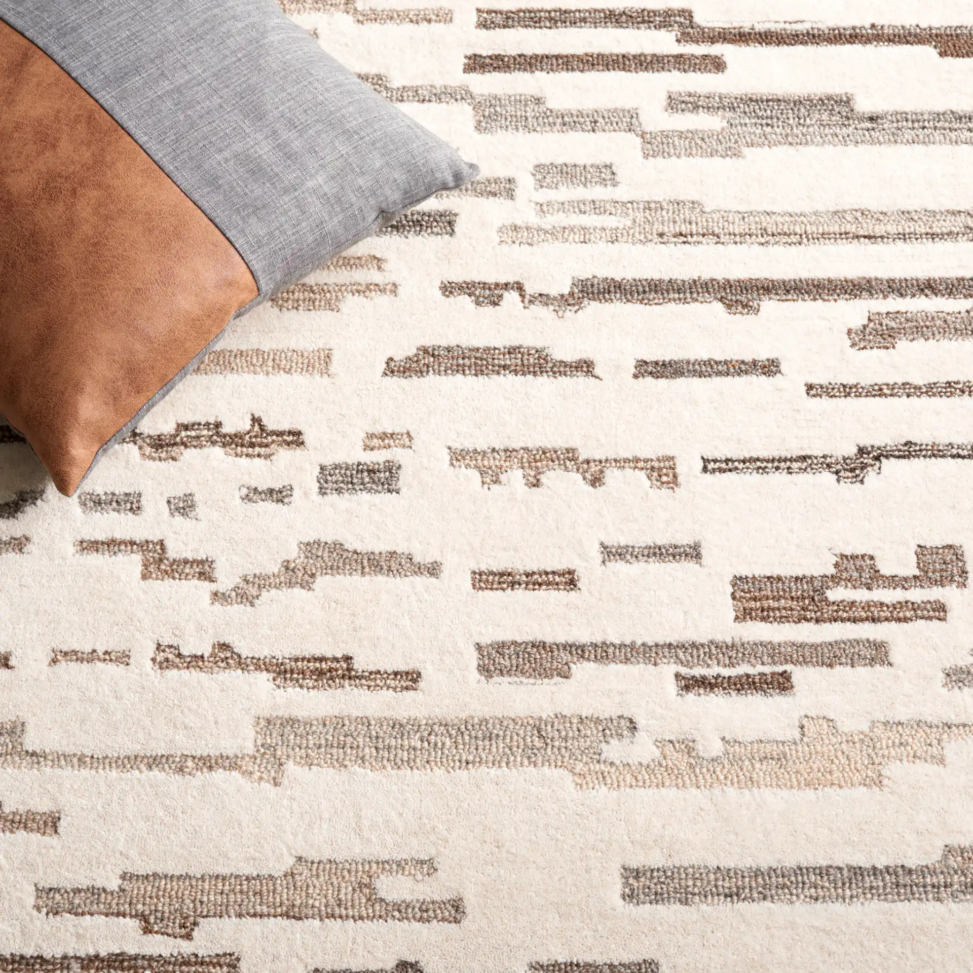 Ebony Linear Abstract Hand-Tufted Wool Rug in Ivory / Gray in a styled room