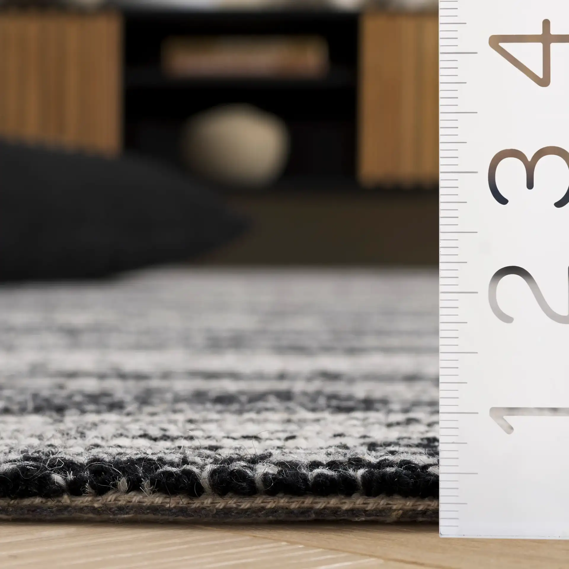 Ebony Broken Stripe Hand-Tufted Wool Rug in Black / Ivory in a styled room