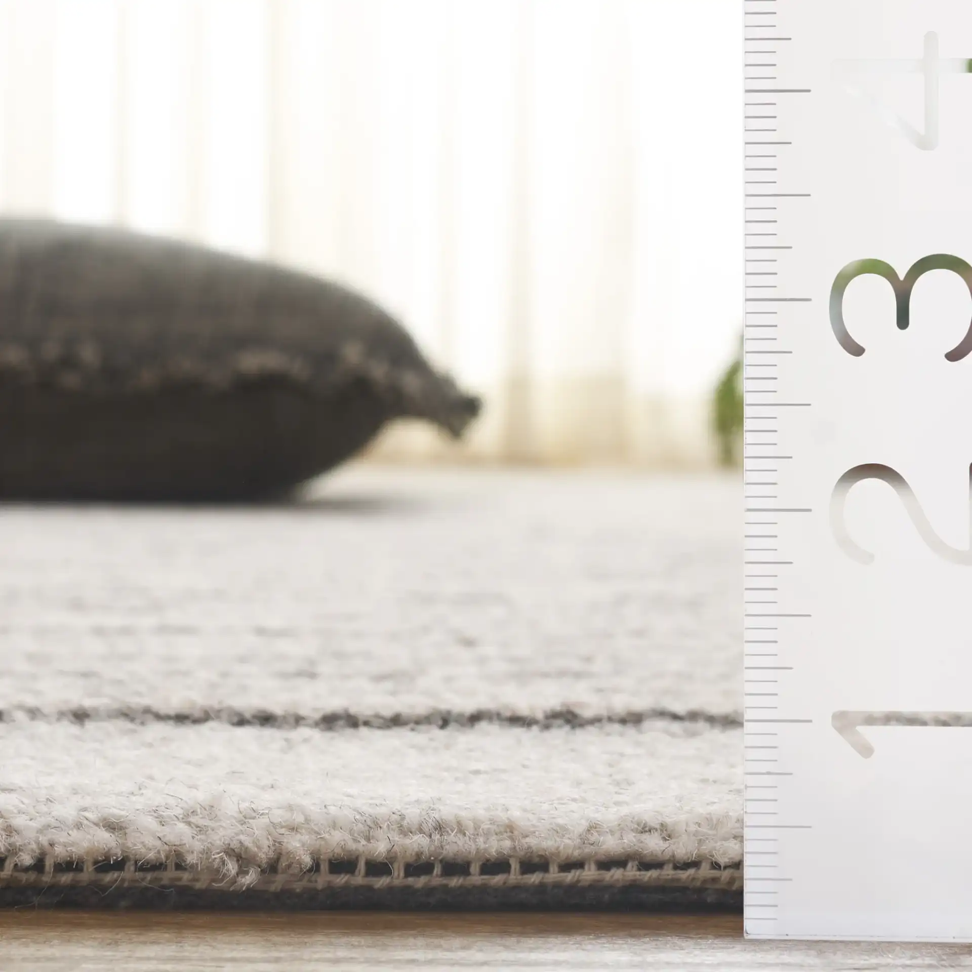 Ebony Dashed Stripe Hand-Tufted Wool Rug in Gray / Black in a styled room