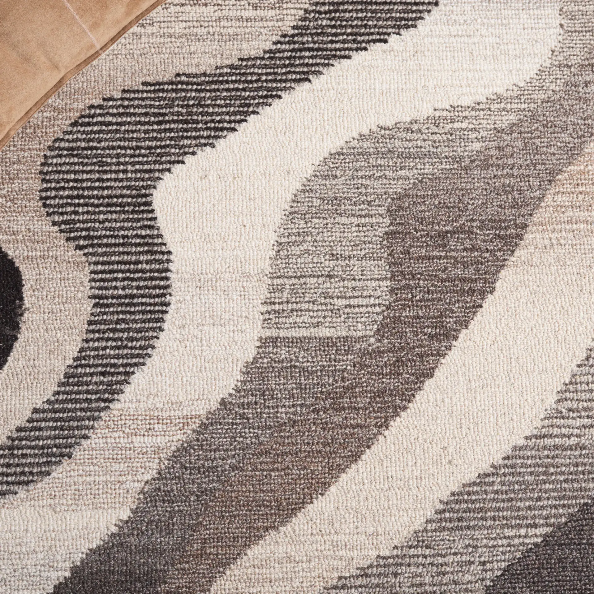 Ebony Abstract Wave Hand-Tufted Wool Rug in Gray / Ivory in a styled room